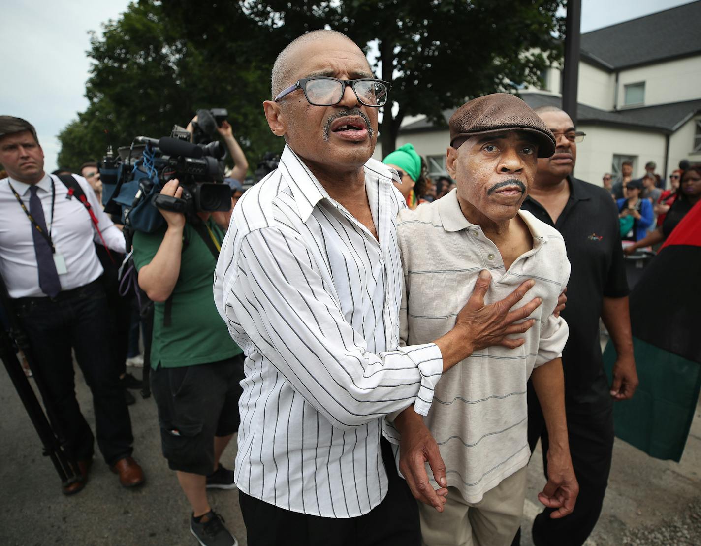 Manuel Moore brother of (Thurman Blevins) left escorted his father Thurman Moore to there car after speaking to members of the north side community during a protest and rally at the 4th precinct. Manuel spoke about his brother and asked for a peaceful protest in front of the police station on Plymouth Avenue in response to the shooting death of Thurman Blevins by Minneapolis Police Sunday June 24, 2018 in Minneapolis, MN. ] JERRY HOLT &#xef; jerry.holt@startribune.com