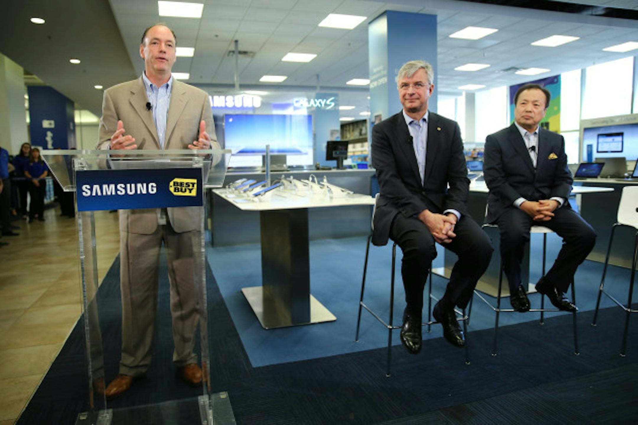 NEW YORK, NY - APRIL 24:  Samsung CEO and President of IT and Mobile Business JK Shin, President of Consumer Electronics Division at Samsung Electronics America Tim Baxter and Best Buy CEO Hubert Joly celebrate the opening of the Samsung Experience Shop at Best Buy Union Square on April 24, 2013 in New York City.  (Photo by Neilson Barnard/Getty Images for Samsung)