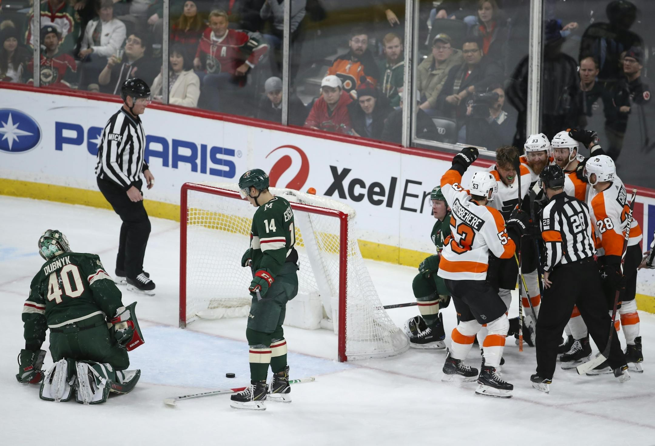 Teammates congratulated Philadelphia Flyers left wing James van Riemsdyk (25), without a helmet, after he scored the game winner in the third period on Wild goaltender Devan Dubnyk (40).
