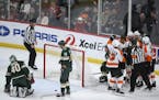 Teammates congratulated Philadelphia Flyers left wing James van Riemsdyk (25), without a helmet, after he scored the game winner in the third period o