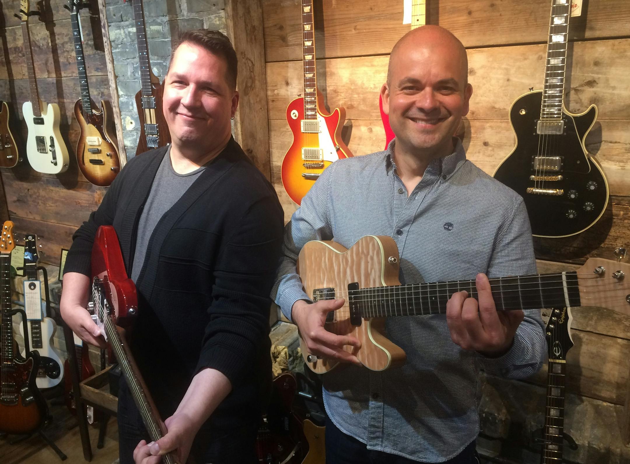 Lee Hall, a guitarist, banker and business advisor at Metropolitan Consortium of Community Developers, and Alan Estevez of El Diablo Amps and Guitar in Northeast Minneapolis. Photo: Neal.St.Anthony@startribune.com