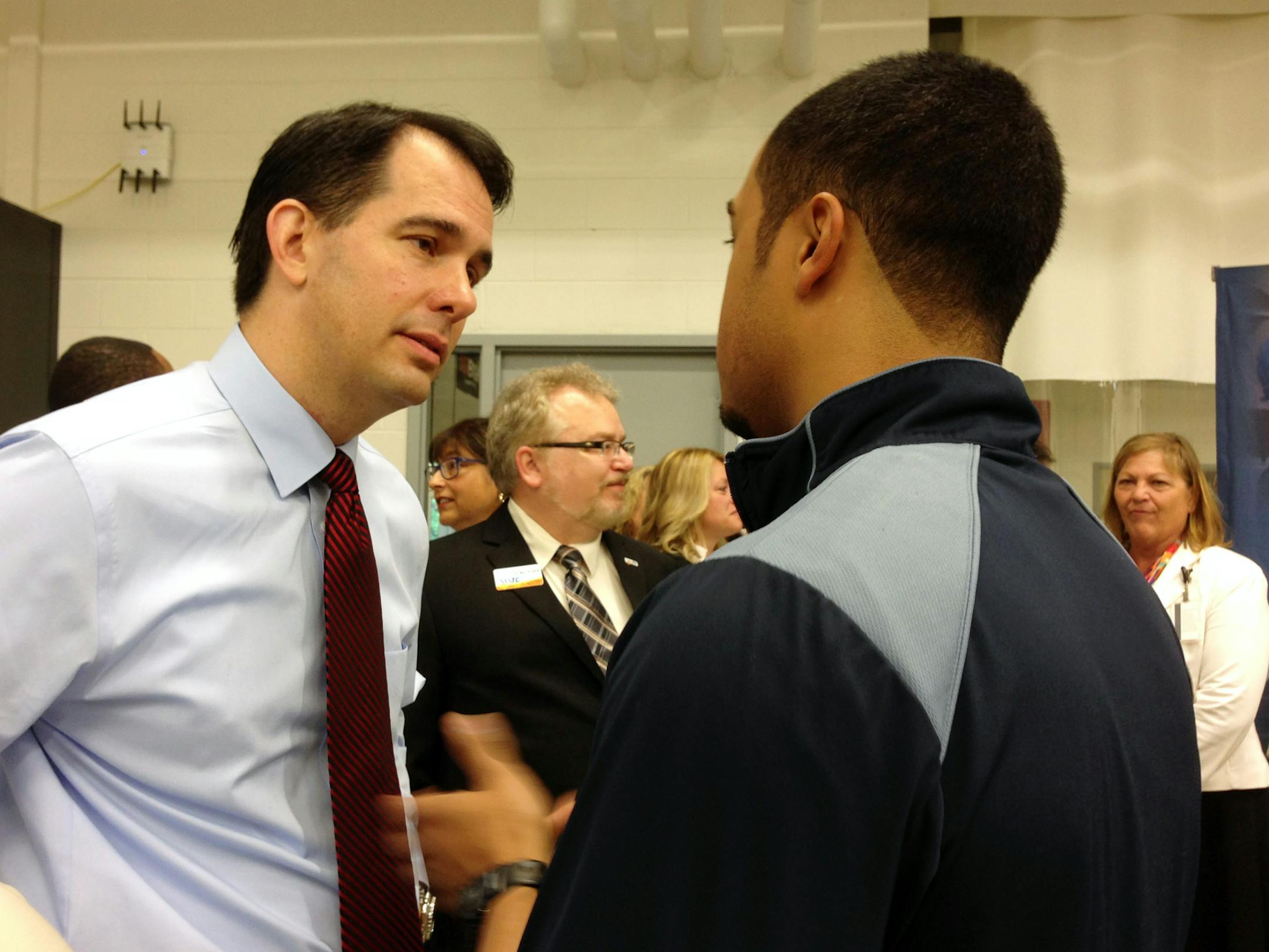 Wisconsin Gov. Scott Walker speaks to Ernesto Gonzalez II at Milwaukee Area Technical College on Friday, July 18, 2014, in Oak Creek, Wis. Walker, whose call to scrap Common Core academic standards for Wisconsin schools is meeting resistance from Republican Senate leaders, said that whatever is adopted may not differ significantly from Common Core standards. (AP Photo/M.L. Johnson) (AP Photo/M.L. Johnson)