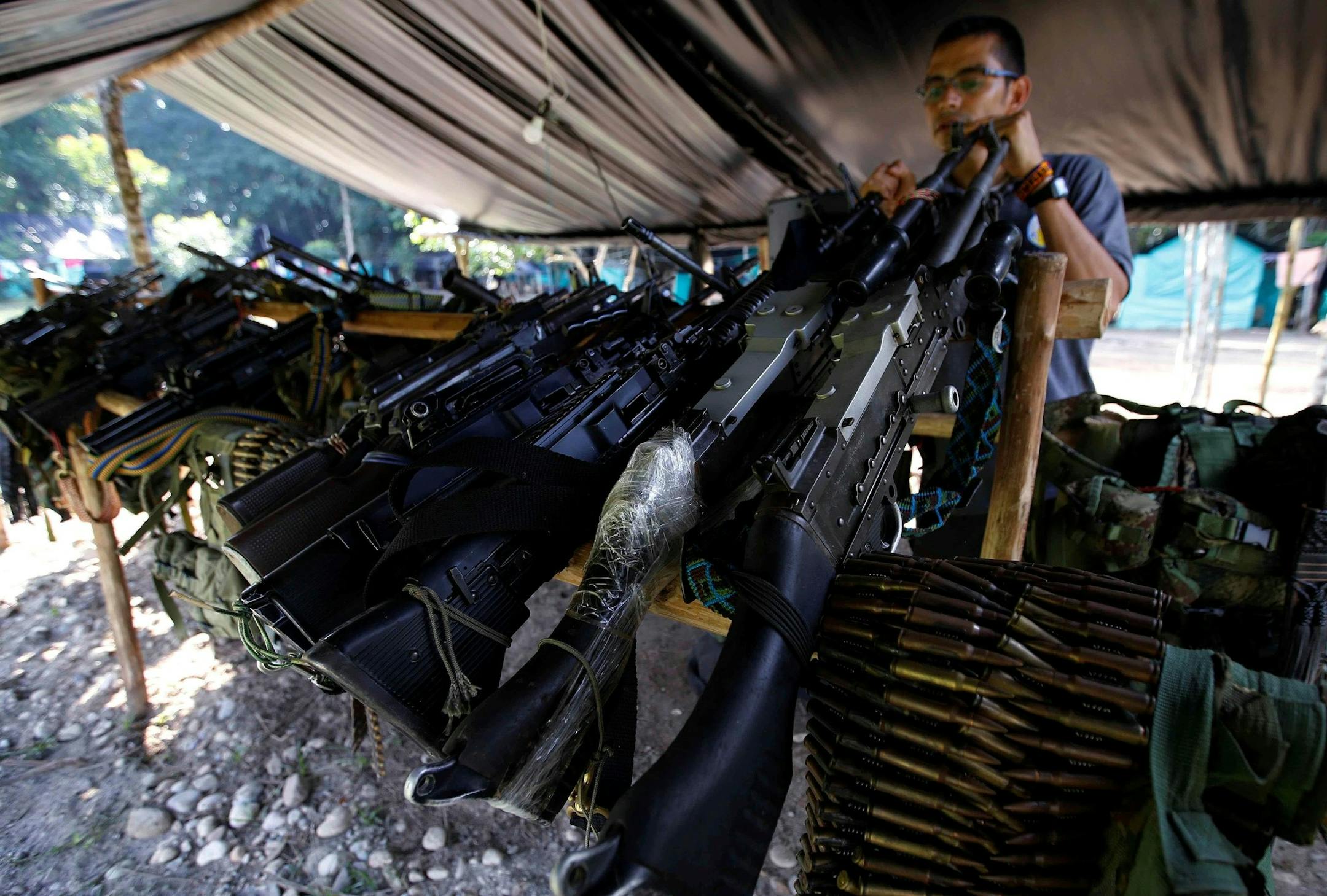 Weapons belonging to rebels of the Revolutionary Armed Forces of Colombia, FARC, are stored at a rebel camp in La Carmelita near Puerto Asis in Colombia's southwestern state of Putumayo, Tuesday, Feb. 28, 2017. March 1 was the deadline for the Revolutionary Armed Forces of Colombia to turn over 30 percent of their arms. But logistical delays setting up the rural camps where rebels are gathered has slowed the process. (AP Photo/Fernando Vergara) ORG XMIT: COFV105