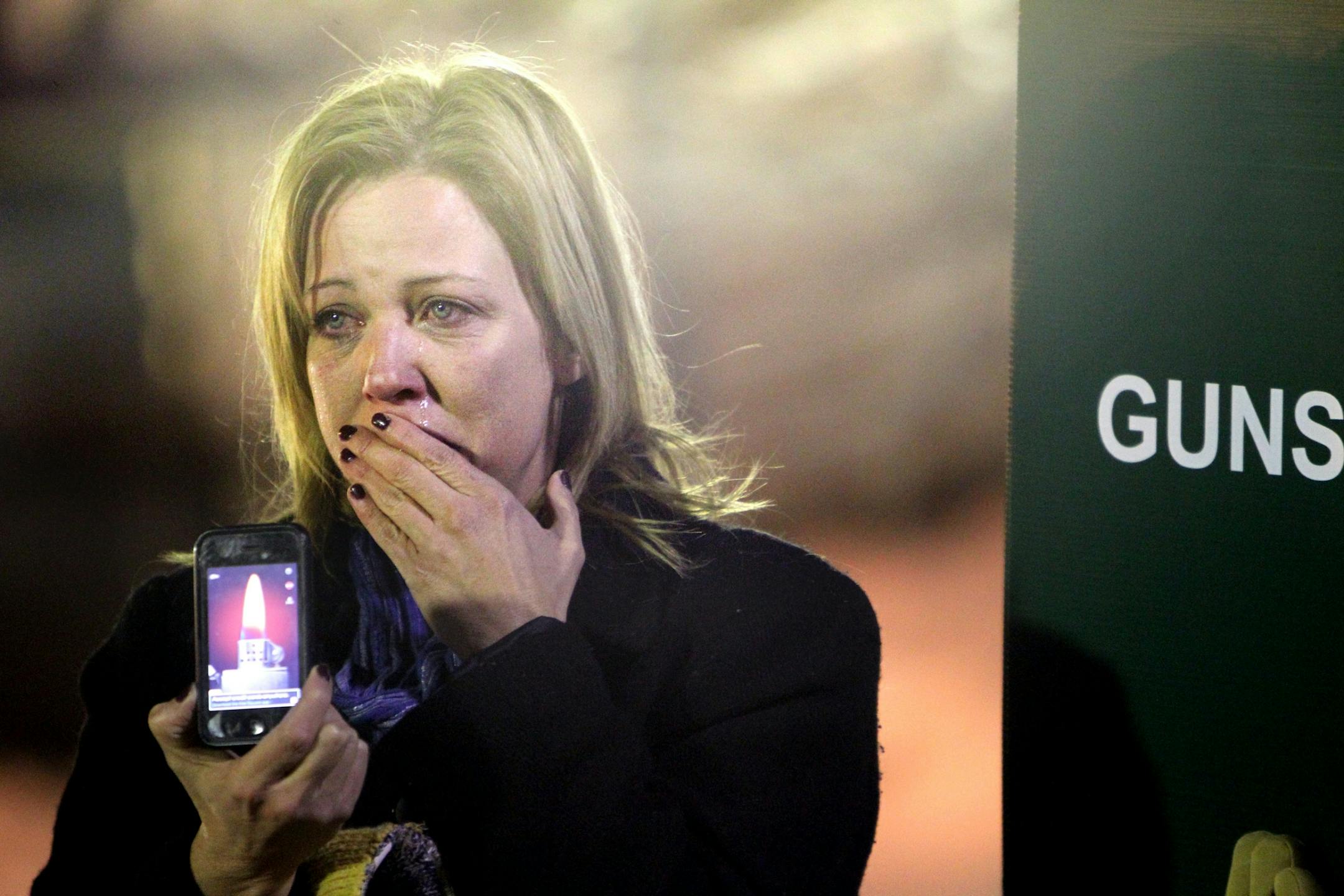 Rebecca Waggoner fought back tears during a rally against gun violence at Martin Luther King Park in Minneapolis December 14, 2012. A mother, Waggoner said, "I just can't wrap my head around this. We need to make the world a different place."