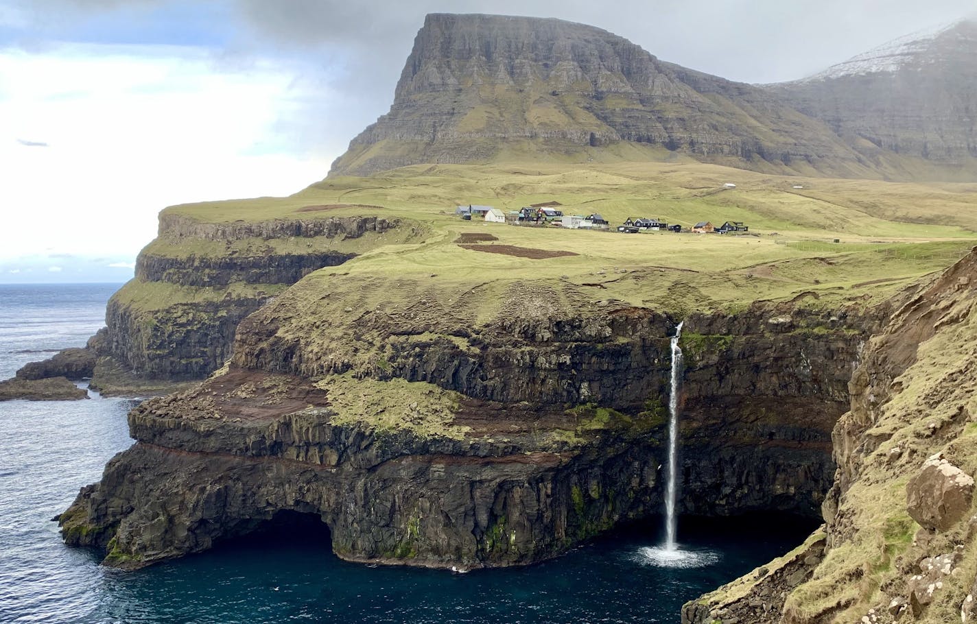 The tiny village of G&#x2021;sadalur on the island of V&#x2021;gar is near what's become one of the most famous attractions on the Faroe Islands: the M&#x153;lafossur waterfall. (Kelly Smith)