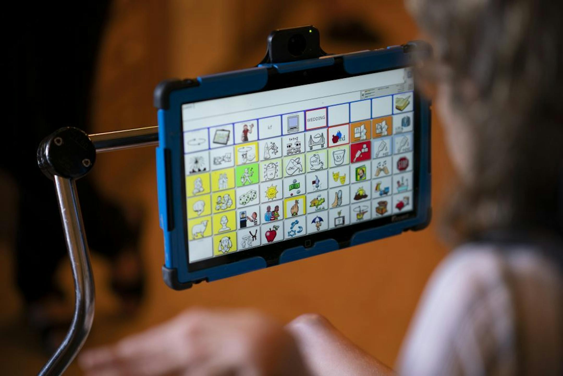 Kari Wagner, who is non-verbal, communicates with the help of a tablet loaded with words that she chooses from.