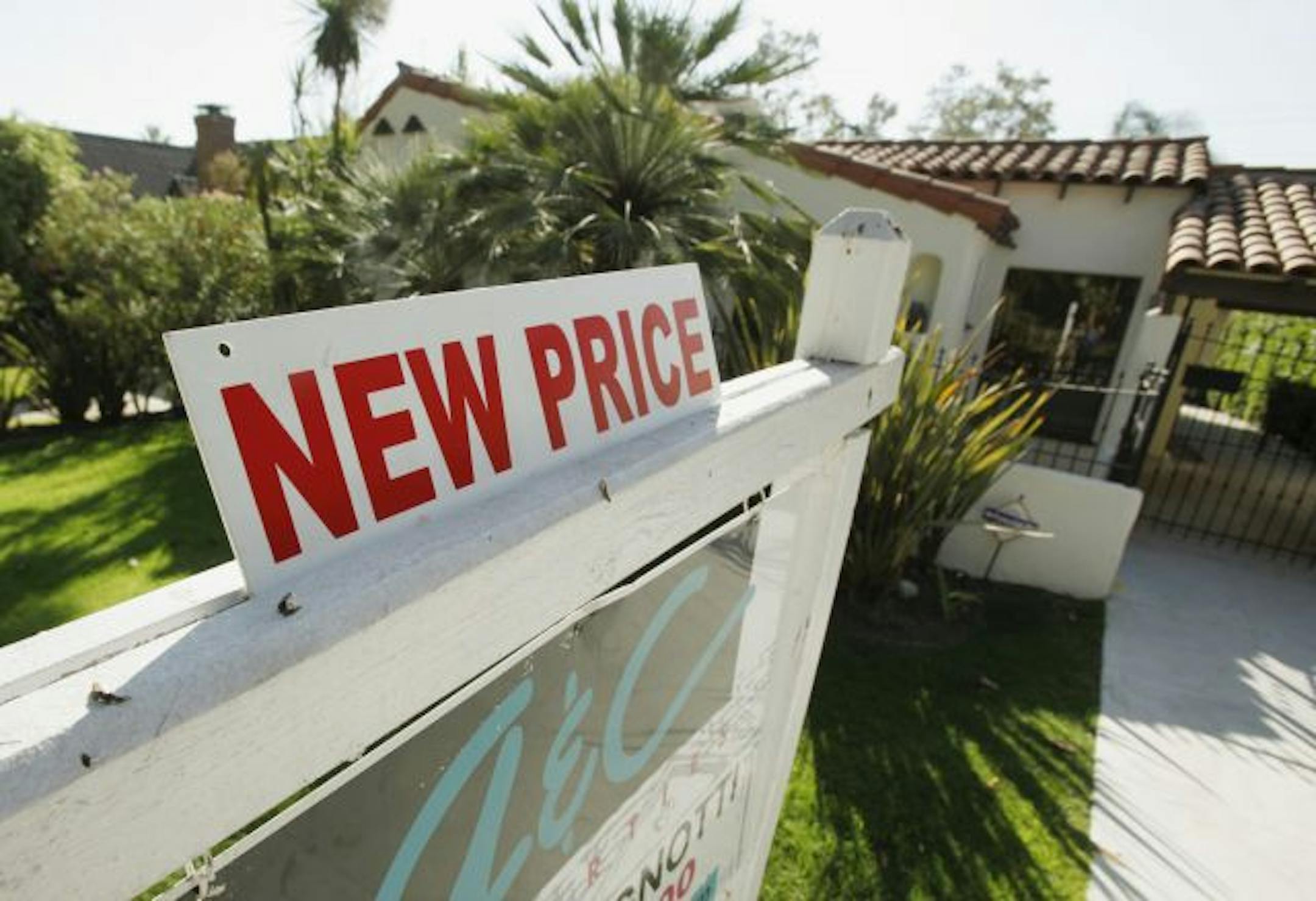 In this Sept. 18, 2010 photo, a "new price" sign has been added to a realtor's sign at a home in Glendale, Calif. Home prices rose in July for the fourth straight month, but many cities are bracing for declines in the year ahead.