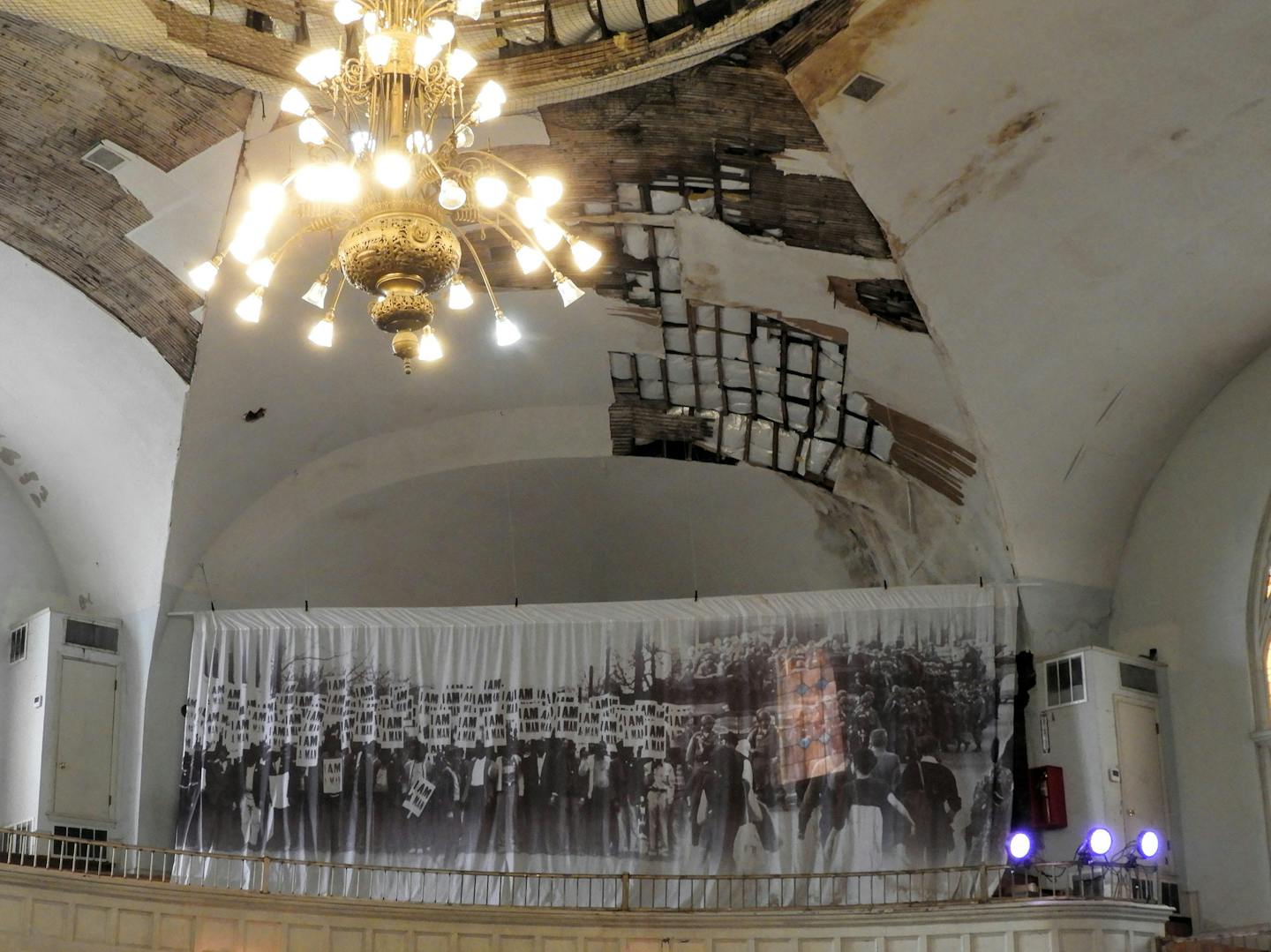 Cracked plaster is visible on the ceiling of Clayborn Temple, the place where sanitation workers organized during their 1968 strike. An image of one of their protest marches hangs from the balcony wall. (Jay Jones/Chicago Tribune/TNS)