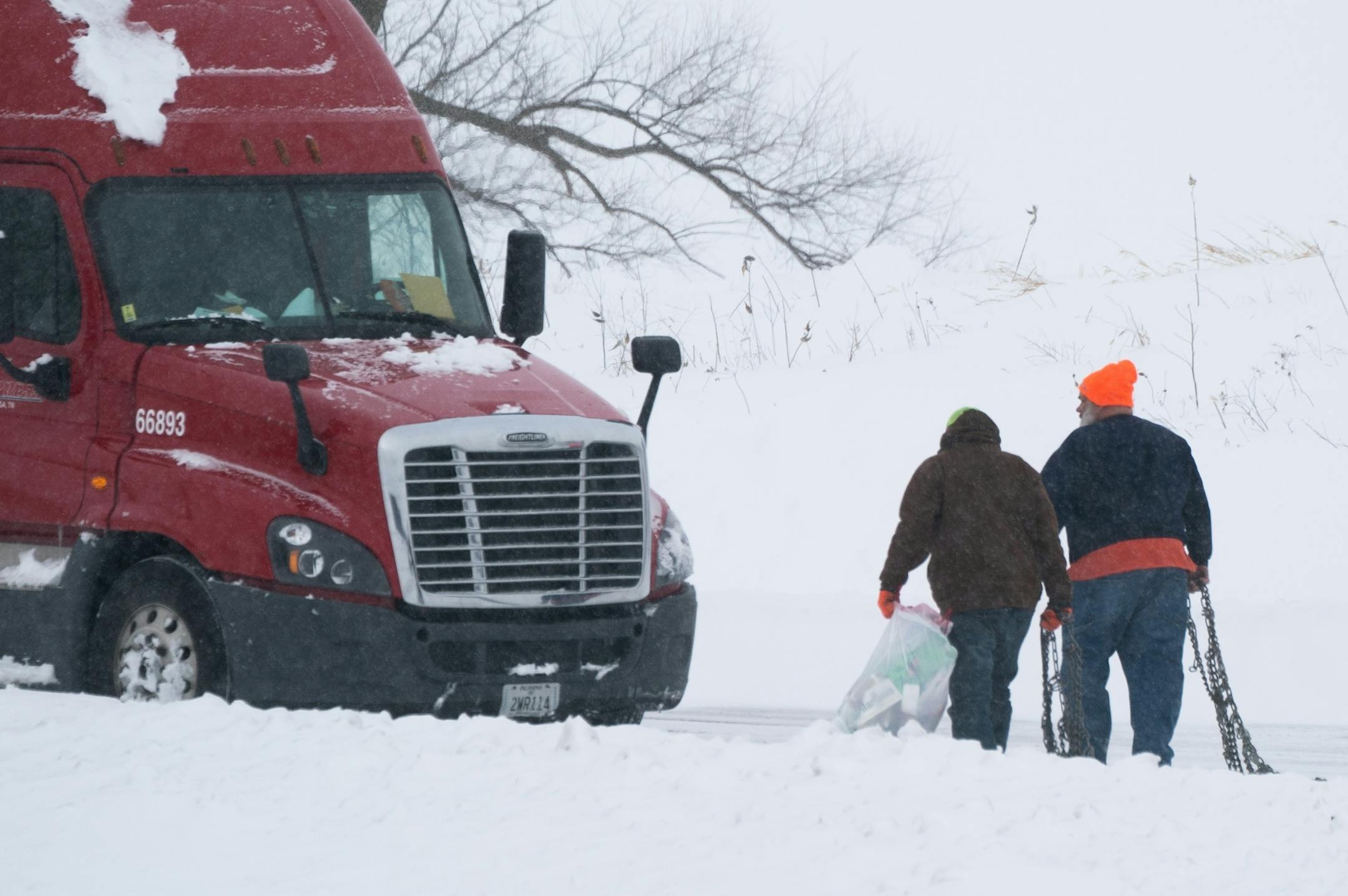 The driver of this semi, left was stuck in a rest stop south of Owatonna, the MNDOT snow plow driver, right was trying to help him.
