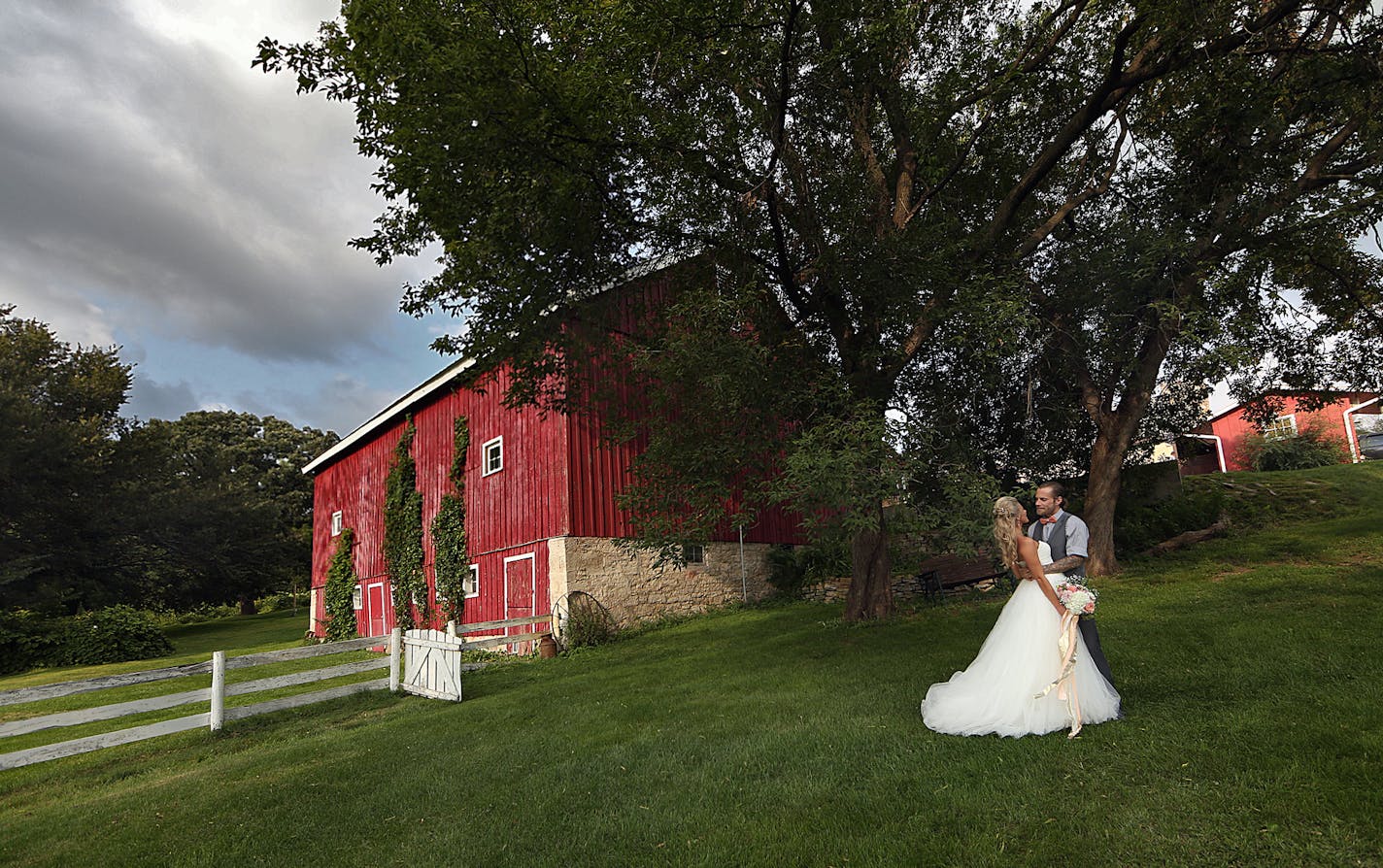 Newlyweds Savannah and Jeremy Eckert posed for photographs following the ceremony. ] JIM GEHRZ &#xef; james.gehrz@startribune.com / Cottage Grove, MN / August 28, 2015 / 3:00 PM &#xf1; BACKGROUND INFORMATION: The sudden flourishing of wedding barns and other farmyard attractions, why the lure of such things just now, and the fightbacks that can happen with neighbors. A wedding is occurring at a wedding barn in Cottage Grove, Hope Glen Farm -- bride Savannah puts on wedding dress 2:20 pm / then b