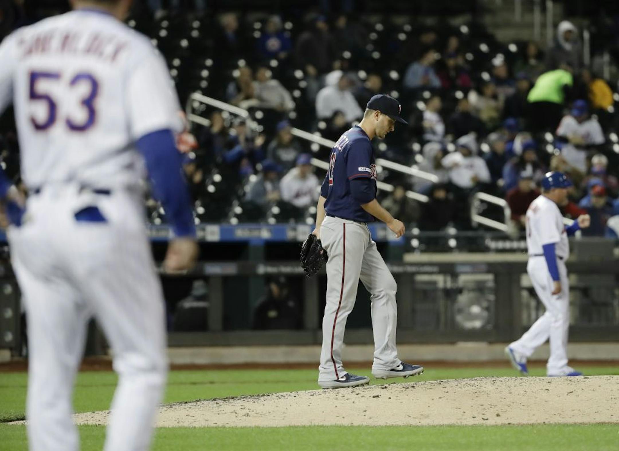 Minnesota Twins starting pitcher Jake Odorizzi (12) reacts after walking New York Mets' Noah Syndergaard to load the bases during the fifth inning of a baseball game Wednesday, April 10, 2019, in New York.