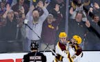 Jaxon Nelson (24) and Bryce Brodzinski (22) of the Minnesota Gophers celebrate a goal by Nelson in the third period. It was Nelson’s second goal of 
