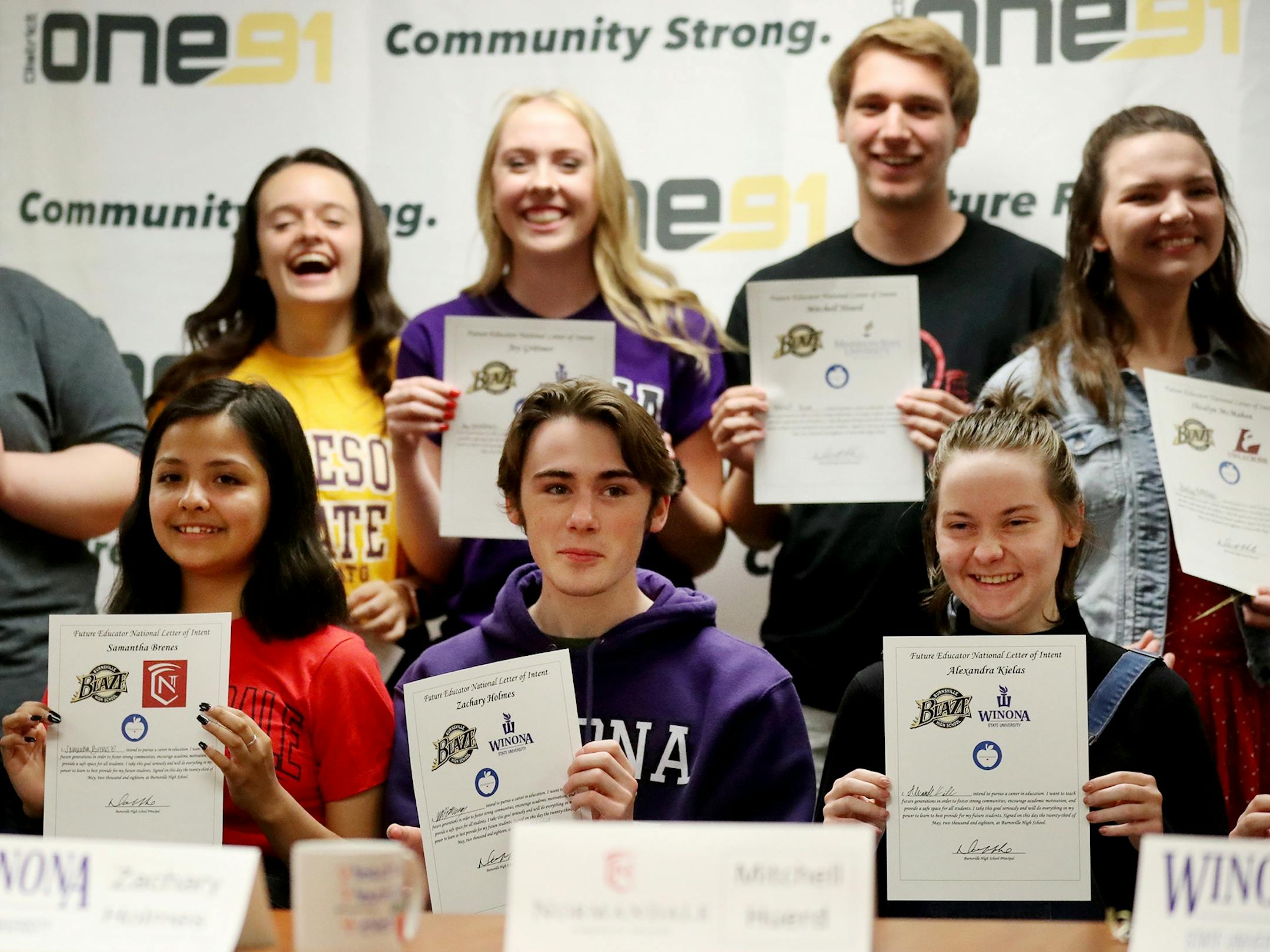 Burnsville High School holds a college signing ceremony for seniors who are planning to become teachers, similar to signing ceremonies for college-bound athletes Wednesday, May 22, 2018, at Burnsville High in Burnsville, MN. Here, nine of 14 Burnsville seniors who participated in the signing ceremony were visible while sitting for a photo after the signing.