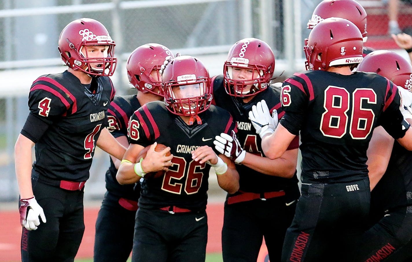 Maple Grove RB Evan Hull (#26) scores on a 5 yard run and celebrates with Crimson teammates as they go on to win 9-6 over Prior Lake at Maple Grove on Friday, September 8th. Photo by Brian W Nelson SportsEngine