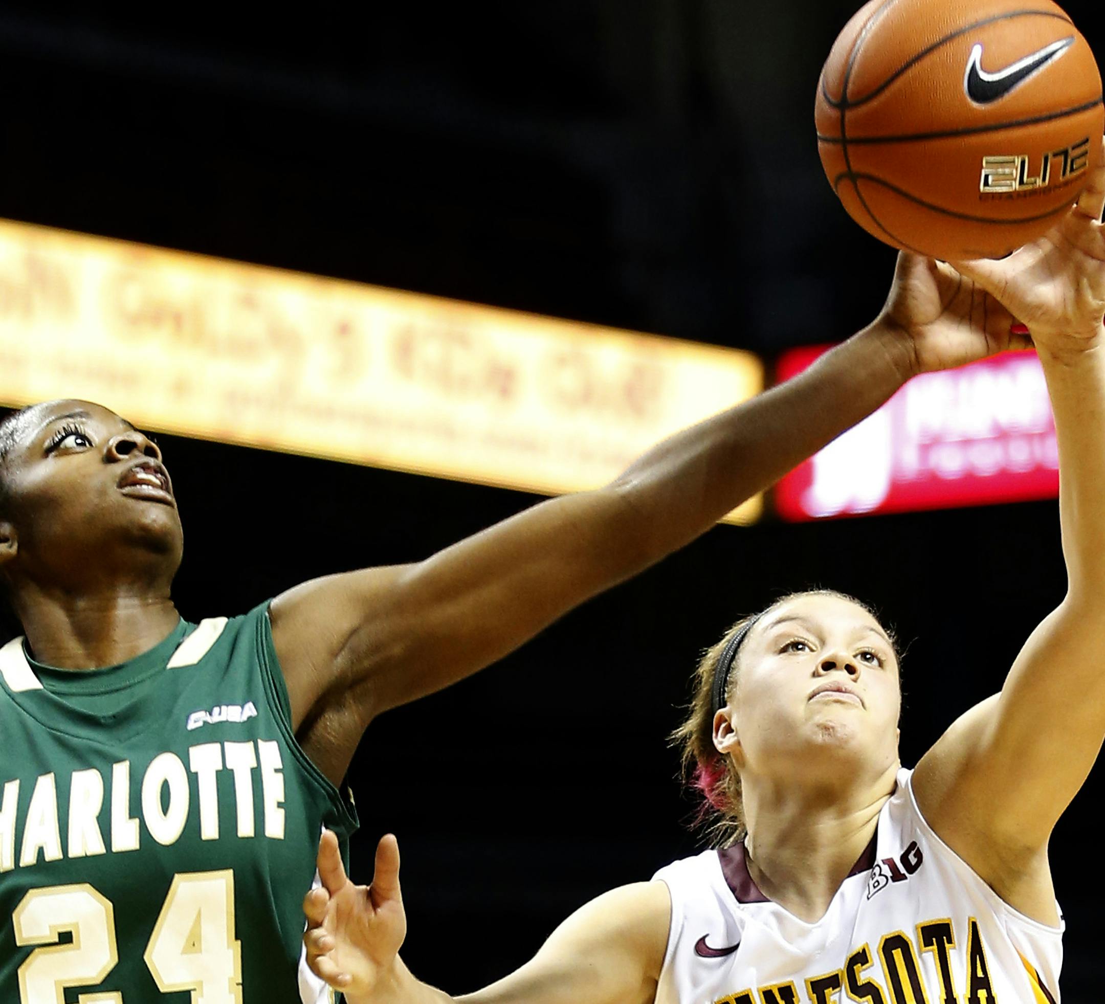 Tori Carter (24) and Rachel Banham (1) fought for a loose ball in the first half. ] CARLOS GONZALEZ cgonzalez@startribune.com November 13, 2013, Minneapolis, Minn., Williams Arena, Womens Basketball, University of Minnesota Gophers vs. Charlotte
