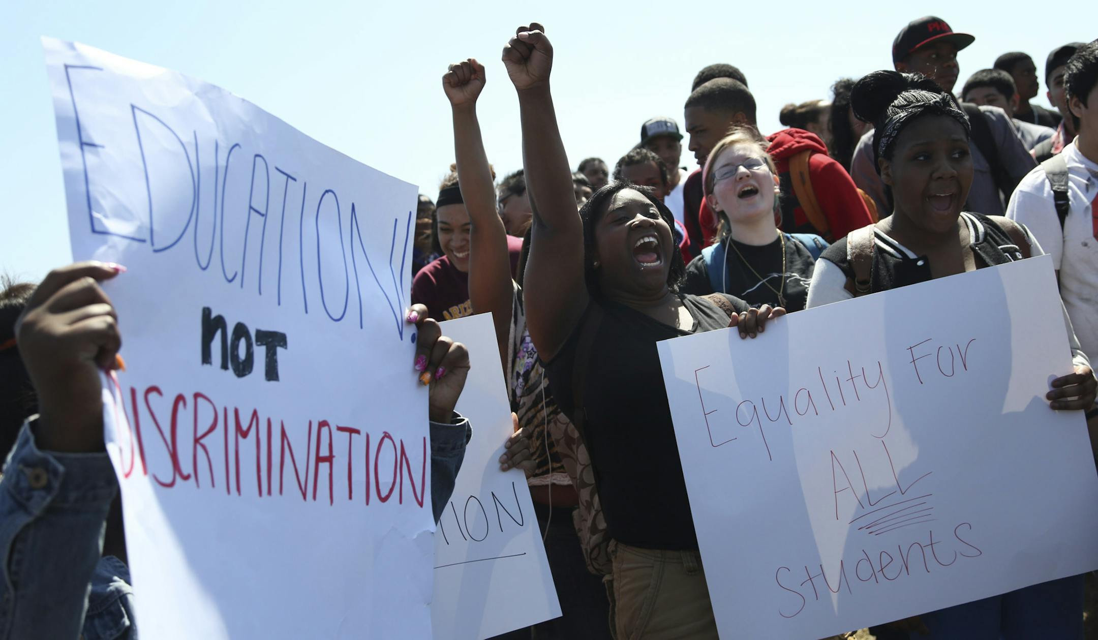 Student Kira Conley, center, chanted for equality with more than 100 other students on one of the fields on the Hopkins High School campus in protest of how students of color have been treated in Hopkins Min., Friday, April 26, 2013. ] (KYNDELL HARKNESS/STAR TRIBUNE) kyndell.harkness@startribune.com