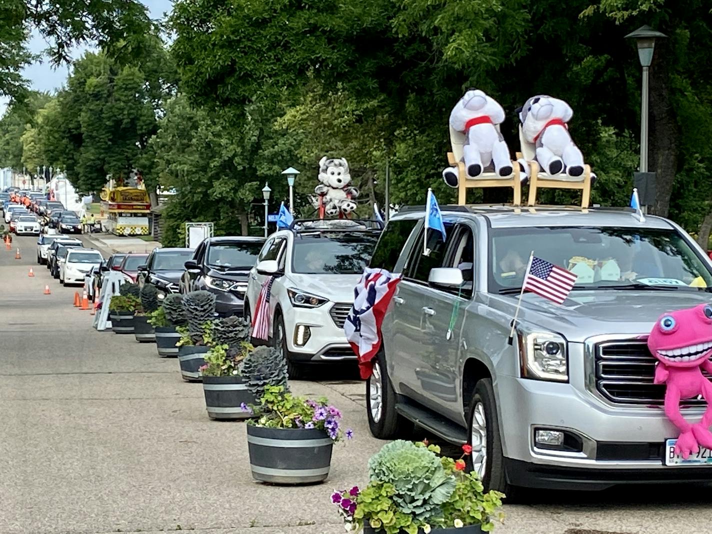 Devin Johnson and Rob Lambert of Lakeville decorated their SUV with winnings from past midway winnings before driving through the Minnesota State Fair Food Parade.