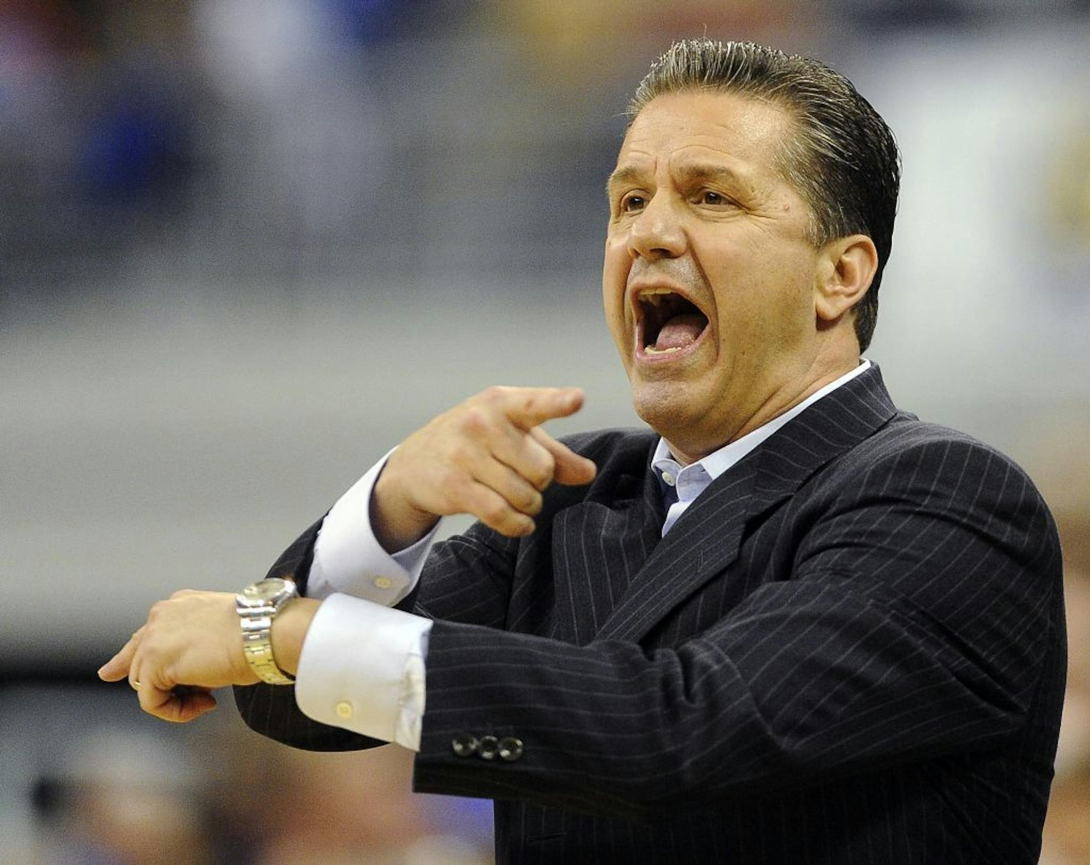 Kentucky head coach John Calipari shouts out instructions to his team during the first half of an NCAA college basketball game against Florida in Gainesville, Fla., Tuesday, Feb. 12, 2013. Florida won 69-52.