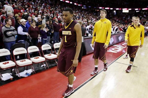 Minnesota's Andre Hollins walks off the court after a 45-44 loss to Wisconsin