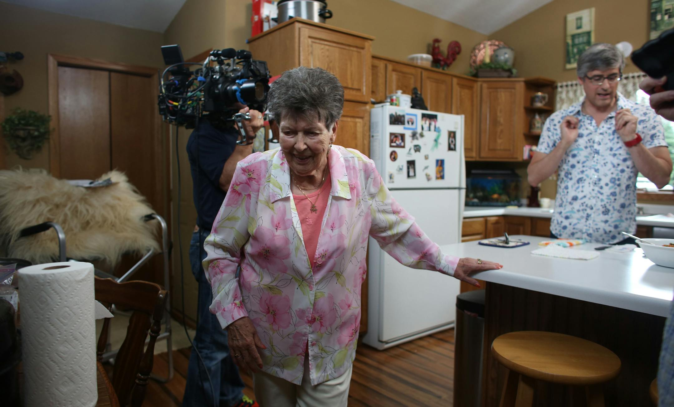 Aslaug Warmboe c headed for her favorite chair as they took a break from filming. ] (KYNDELL HARKNESS/STAR TRIBUNE) kyndell.harkness@startribune.com Home of Aslaug Warmboe in Hastings, Min. Tuesday, July 1, 2014. Humorist Mo Rocca is taping an episode of his show, "My Grandmother's Ravioli," in which he interviews grandparents across the country about their favorite recipes.