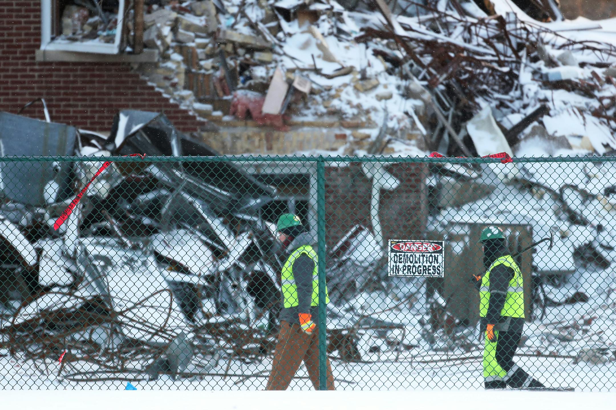 Construction crews begin demolition of the Minnehaha Academy campus damaged by a natural gas explosion. Here, workers walk by the rubble from the explosion Tuesday, Dec. 5, 2017, in Minneapolis, MN.] DAVID JOLES ï david.joles@startribune.com Construction crews begin demolition of the Minnehaha Academy campus damaged by a natural gas explosion. ,cq