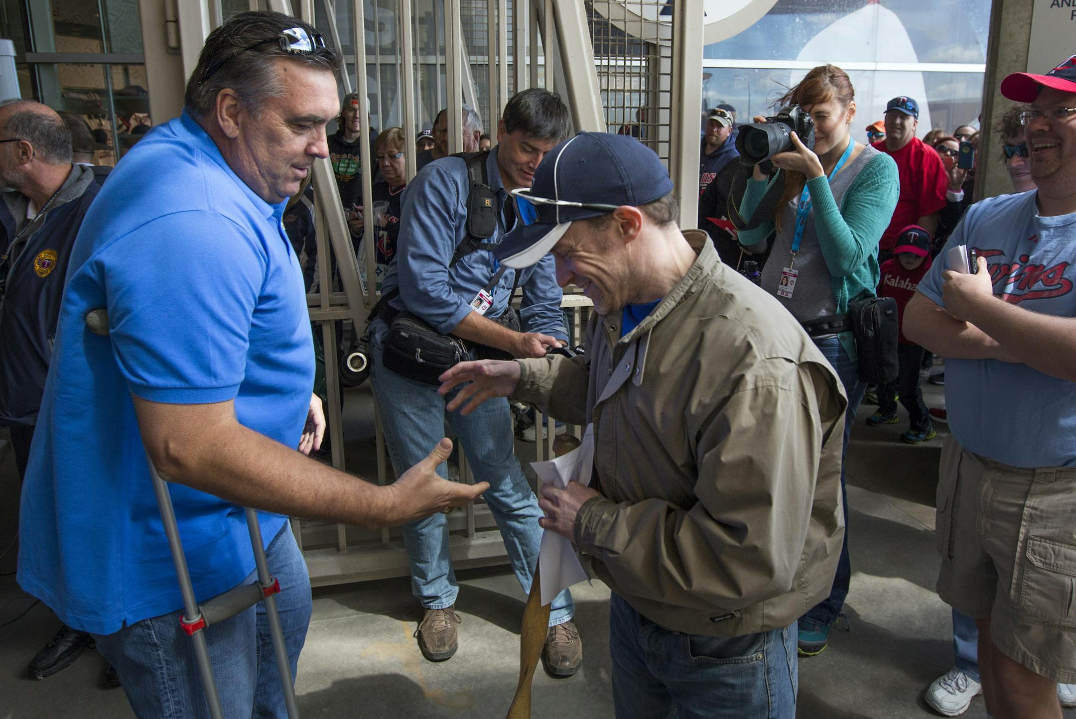 Twins legendary first baseman Kent Hrbek greets the first fan, Justin Kunz of St. Paul, through gate 14 at Target Field. Minnesota Twins Home Opener ] Minneapolis, MN - 4/13/2015