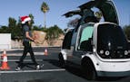 A worker loads an order into a Nuro mini car, which is a self-driving vehicle, outside Fry&#x2019;s Food Store in Scottsdale, Ariz., Dec. 13, 2018. Nu