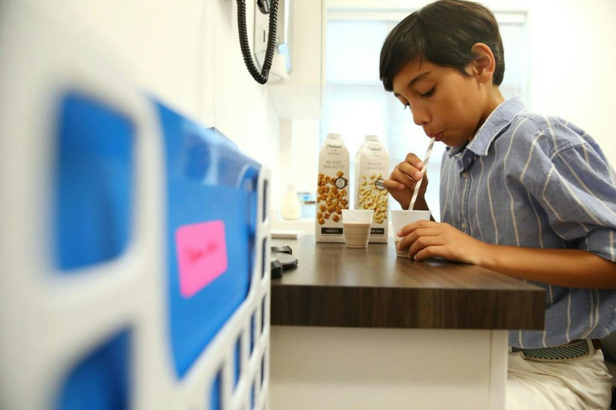 Eleven-year-old Mathieu Bui of Chicago drinks 90 milliliters of walnut milk and cashew milk as part of a treatment to eliminate his allergies at Kenilworth Medical Associates on Wednesday, Sept. 18, 2019 in Kenilworth, Ill. Bui has allergies to five tree nuts, including peanuts, walnuts, pecans, cashews and pistachios. In March of 2018 he began undergoing treatment to be desensitized to these nuts under the medical care of Dr. Paul Detjen. He is already able to eat peanuts and is expected to be