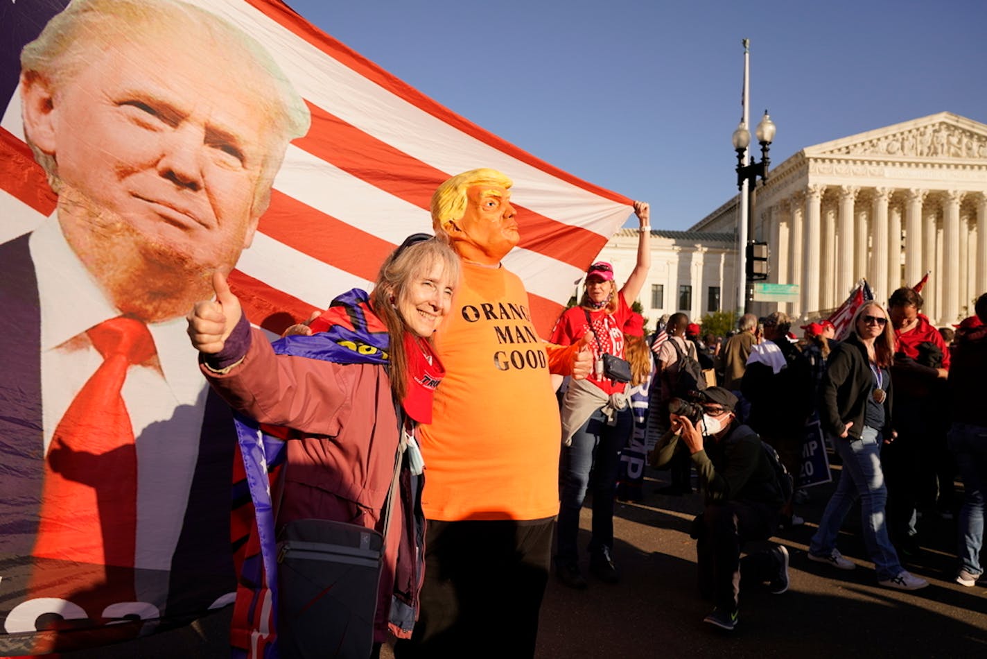 People pose for a photo as supporters of President Donald Trump attend pro-Trump marches outside the Supreme Court building, Saturday Nov. 14, 2020, in Washington. (AP Photo/Jacquelyn Martin)