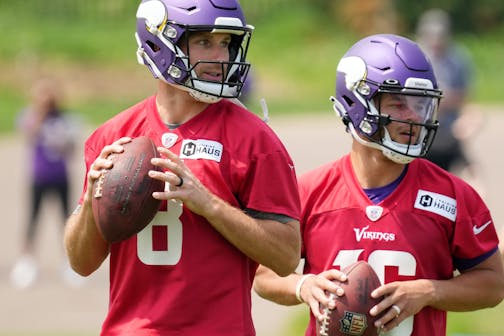 Minnesota Vikings quarterbacks Kirk Cousins (8) and Jaren Hall (16) look to throw during offseason organized team activities.