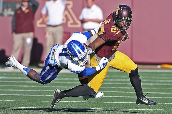Senior running back David Cobb sported the maroon helmet, maroon jersey and gold pants look in the Gophers&#x2019; second game of the season against M