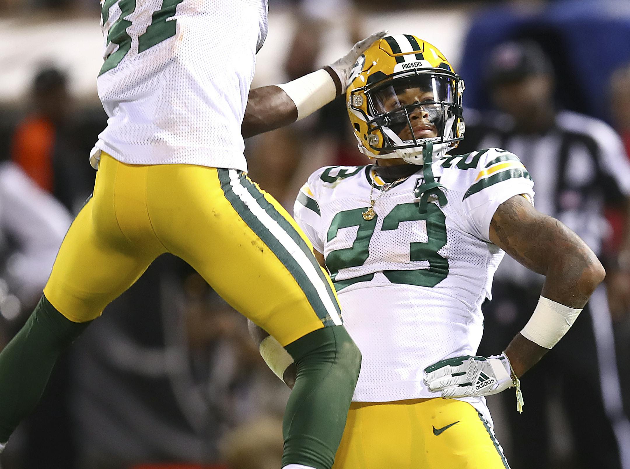 Green Bay Packers cornerback Jaire Alexander (23) celebrates with cornerback Josh Jackson (37) after Alexander intercepted a pass against the Oakland Raiders during the first half of an NFL preseason football game in Oakland, Calif., Friday, Aug. 24, 2018. (AP Photo/Ben Margot)