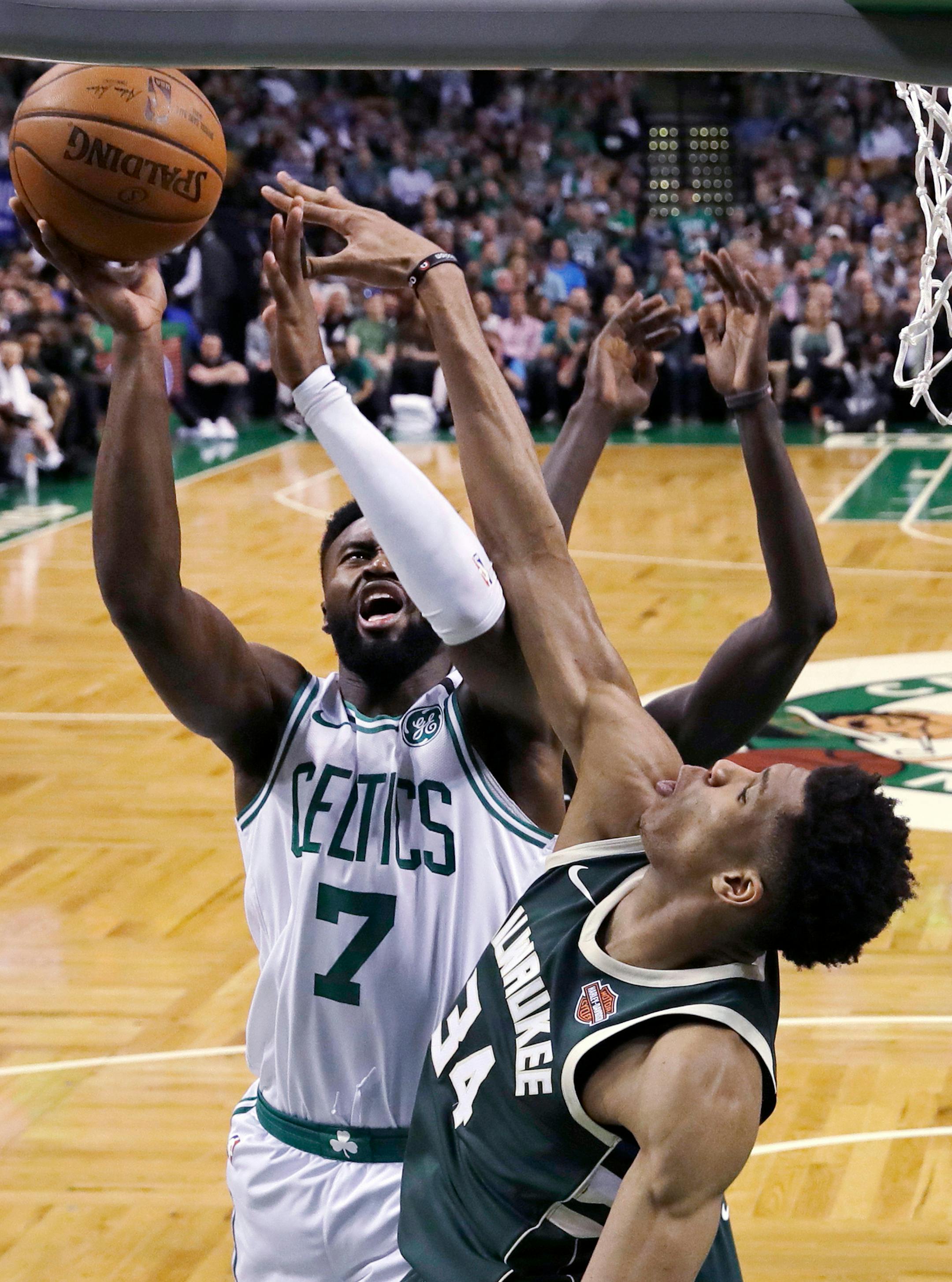 Boston Celtics guard Jaylen Brown (7) is pressured by Milwaukee Bucks forward Giannis Antetokounmpo, right, on a drive to the basket during the second quarter of Game 7 of an NBA basketball first-round playoff series in Boston, Saturday, April 28, 2018. (AP Photo/Charles Krupa)