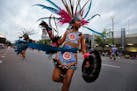 An Aztec dancer from Kalpulli KetzalCoatlicue in the 2016 Aquatennial Torchlight Parade.