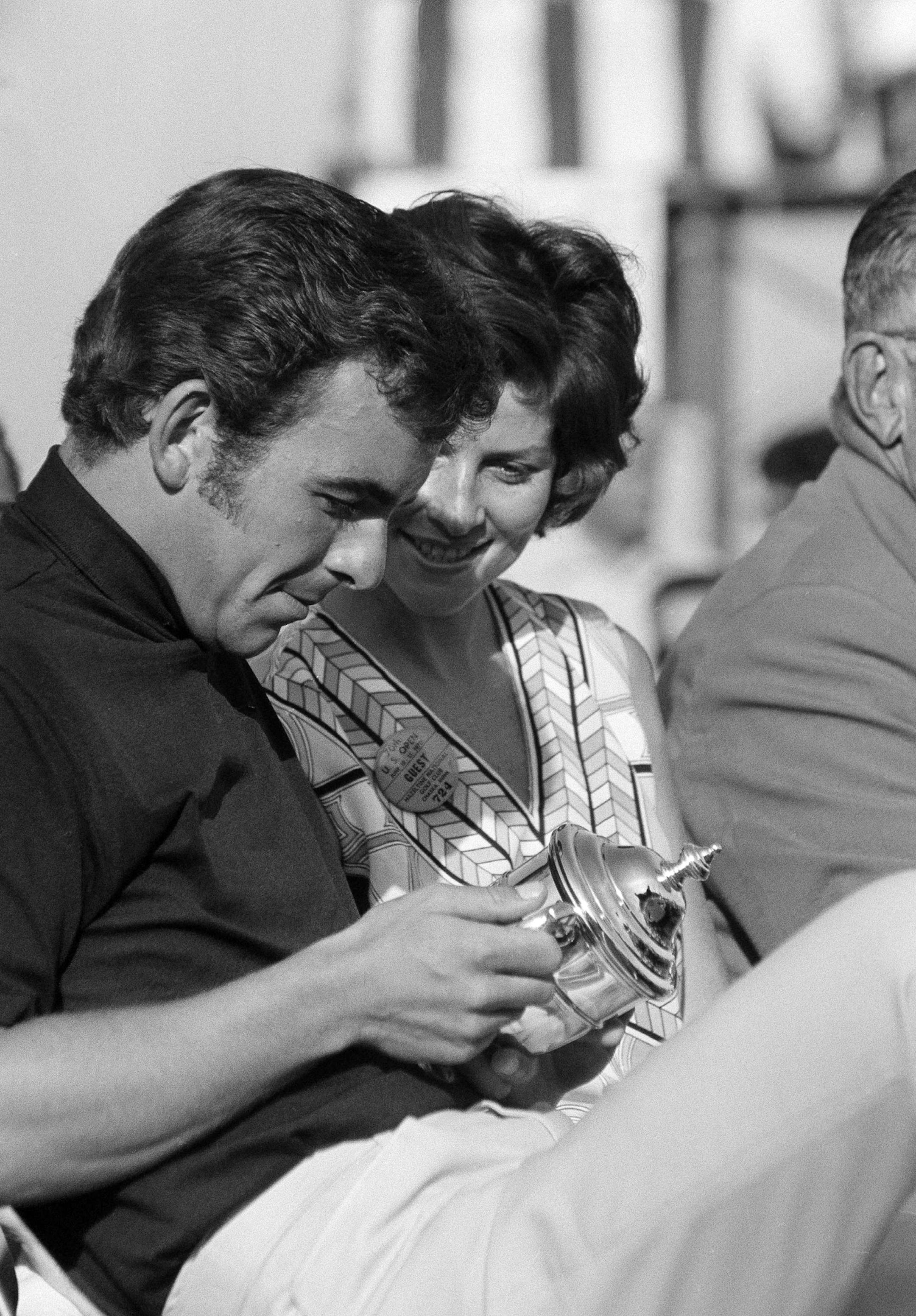 Tony Jacklin, British Open champion, and his wife Vivien, look at the small U.S. Open Championship trophy that he will keep, in Chaska, Minn., June 22, 1970. The small cup is a replica of the larger one that he must return for the next winner in 1971. Jacklin was presented with the trophy after winning the U.S. Open title. (AP Photo) ORG XMIT: APHS455800