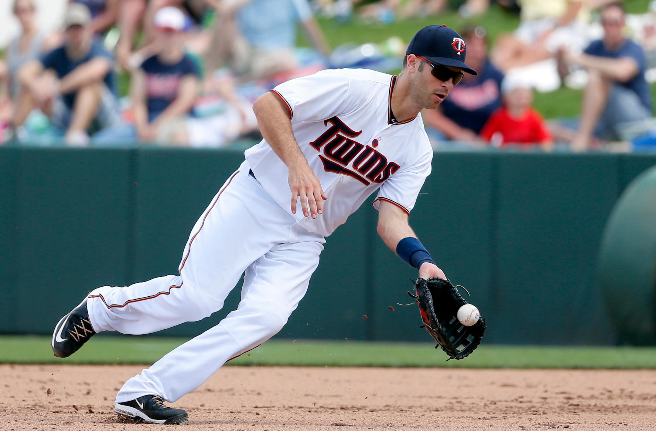 Minnesota Twins first baseman Joe Mauer fields a ground out by Tampa Bay Rays' Kyle Roller in the sixth inning of a spring training baseball game, Wednesday, March 23, 2016, in Fort Myers, Fla. (AP Photo/Tony Gutierrez)