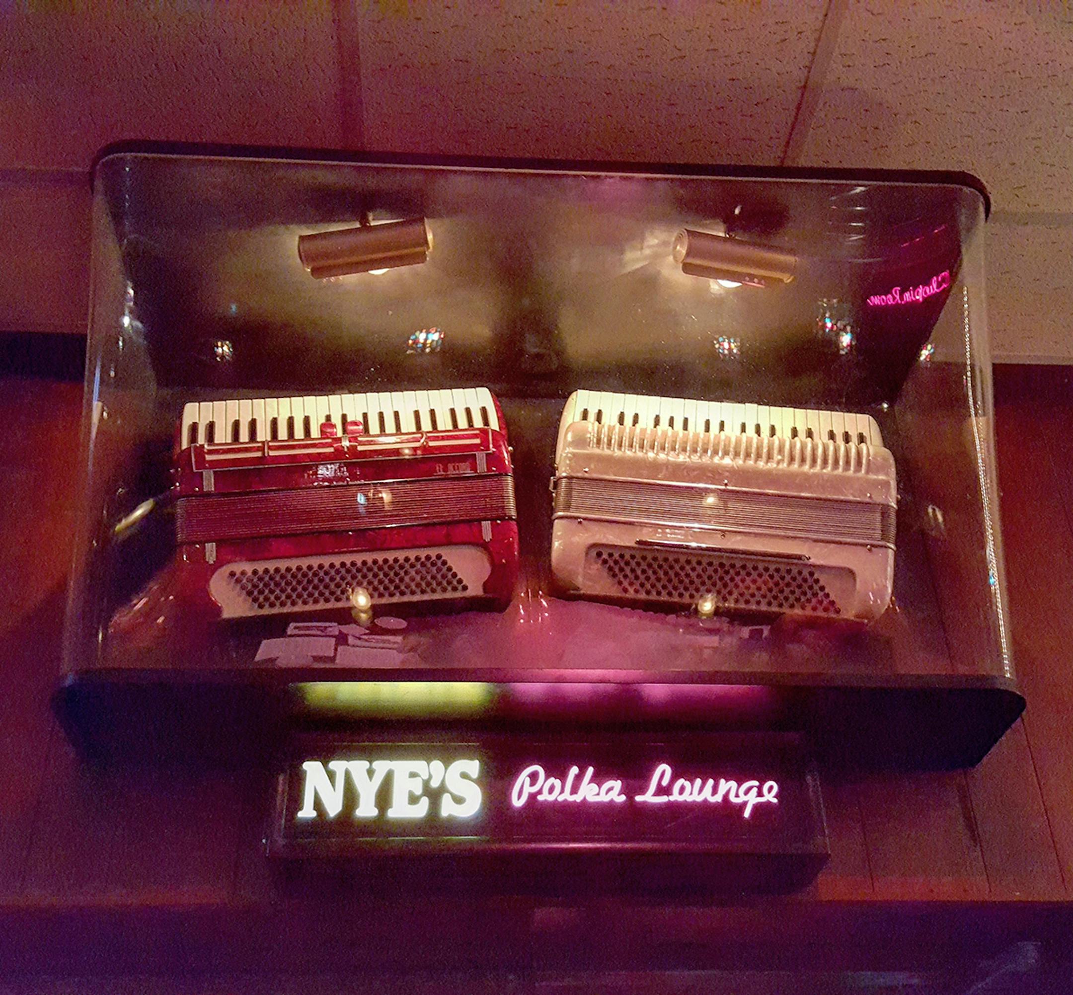 Credit: Cat A. Strophoea (or Cat M.) These two accordians have pride of place; they're mounted in a special display case above Nye's Polka Lounge, where y'can dance to Th' World's Most Dangerous Polka Band and drink a Nordeast beer
