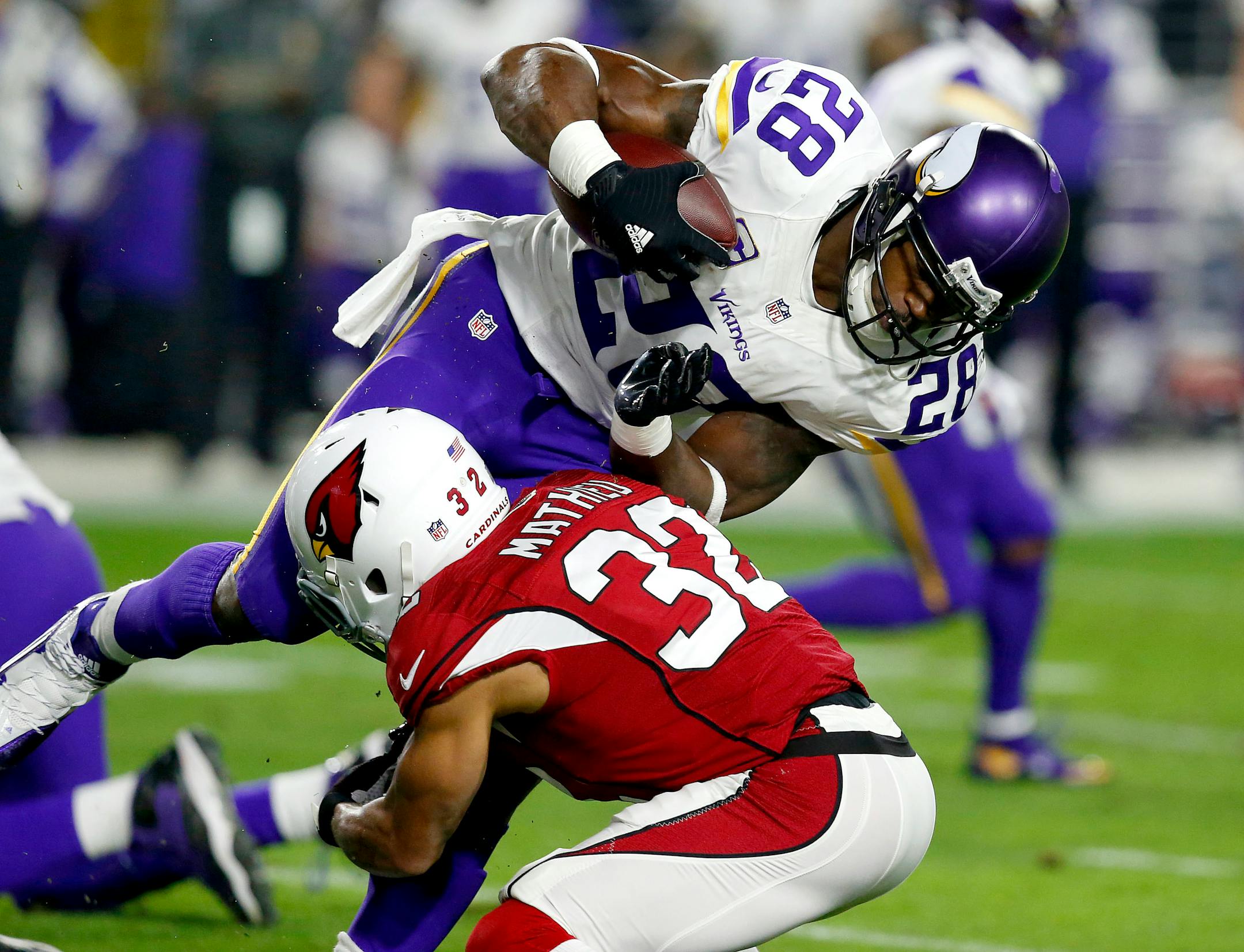 Minnesota Vikings running back Adrian Peterson (28) is hit by Arizona Cardinals free safety Tyrann Mathieu (32) during the first half of an NFL football game, Thursday, Dec. 10, 2015, in Glendale, Ariz. (AP Photo/Rick Scuteri)