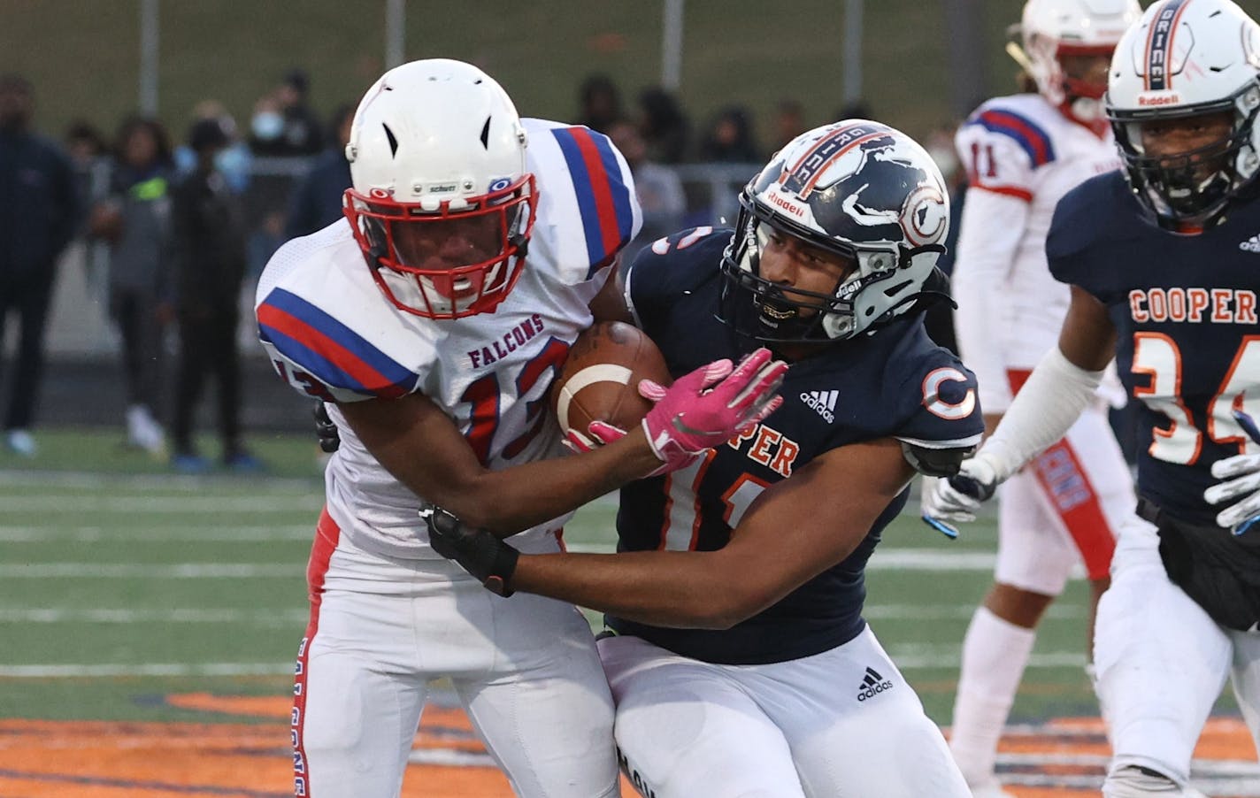 Robbinsdale Armstrong's Kayden College (14) carries the ball while being pursued by Robbinsdale Cooper's Jaxon Howard (11) in the first half. Photo by Cheryl A. Myers, SportsEngine