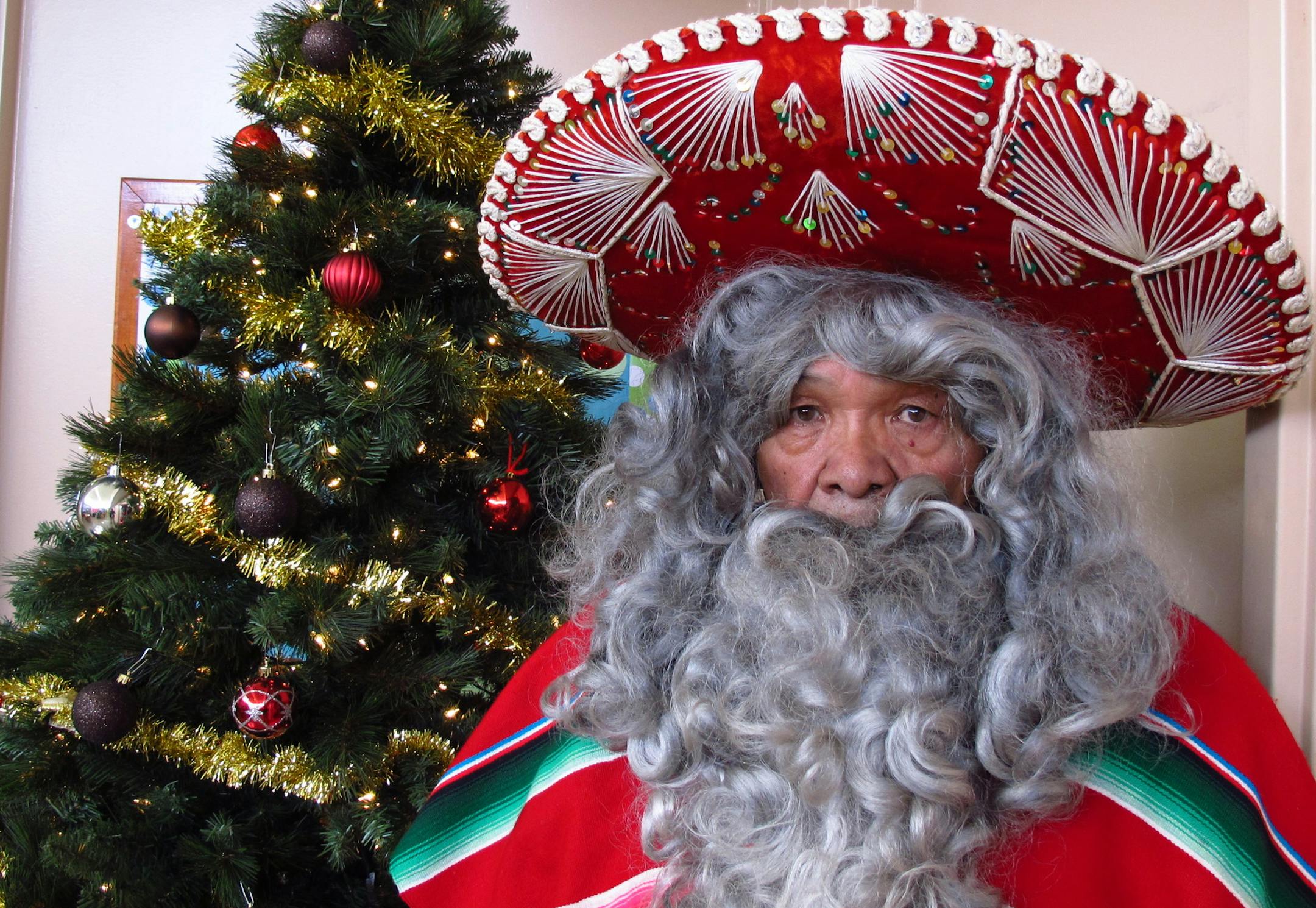 In this Wednesday, Dec. 18, 2013, photo, Julian Perez stands in his Pancho Claus suit in Lubbock, Texas. The retired 71-year-old has donned the Pancho Claus suit for 30 years to hand out gifts for low-income and at-risk children. (AP Photo/Betsy Blaney)