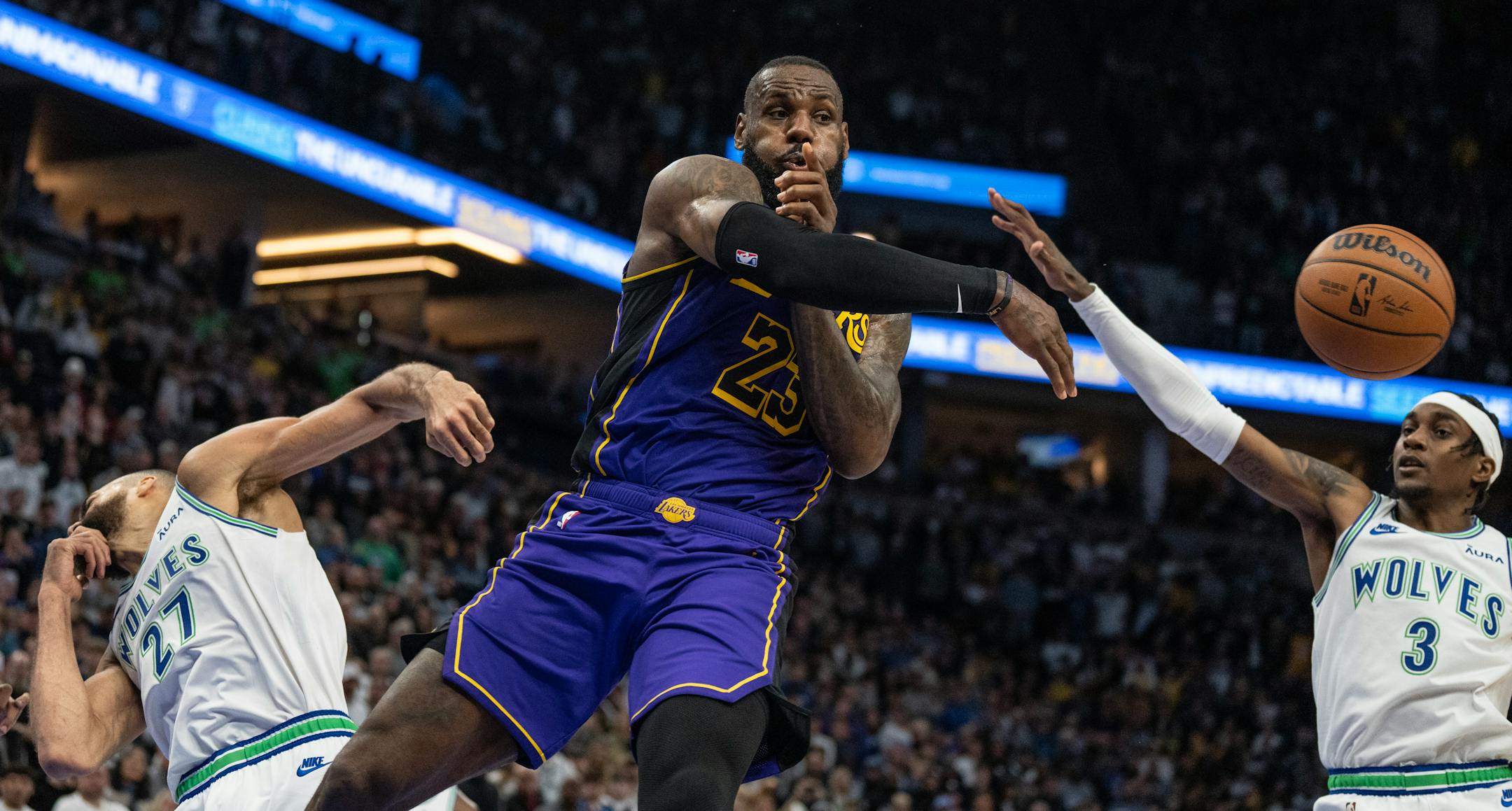 Los Angeles Lakers forward LeBron James (23) pass the ball around Minnesota Timberwolves forward Jaden McDaniels (3) in the fourth quarter Saturday December ,30, 2023 in, Minneapolis, Minn. ] JERRY HOLT • jerry.holt@startribune.com