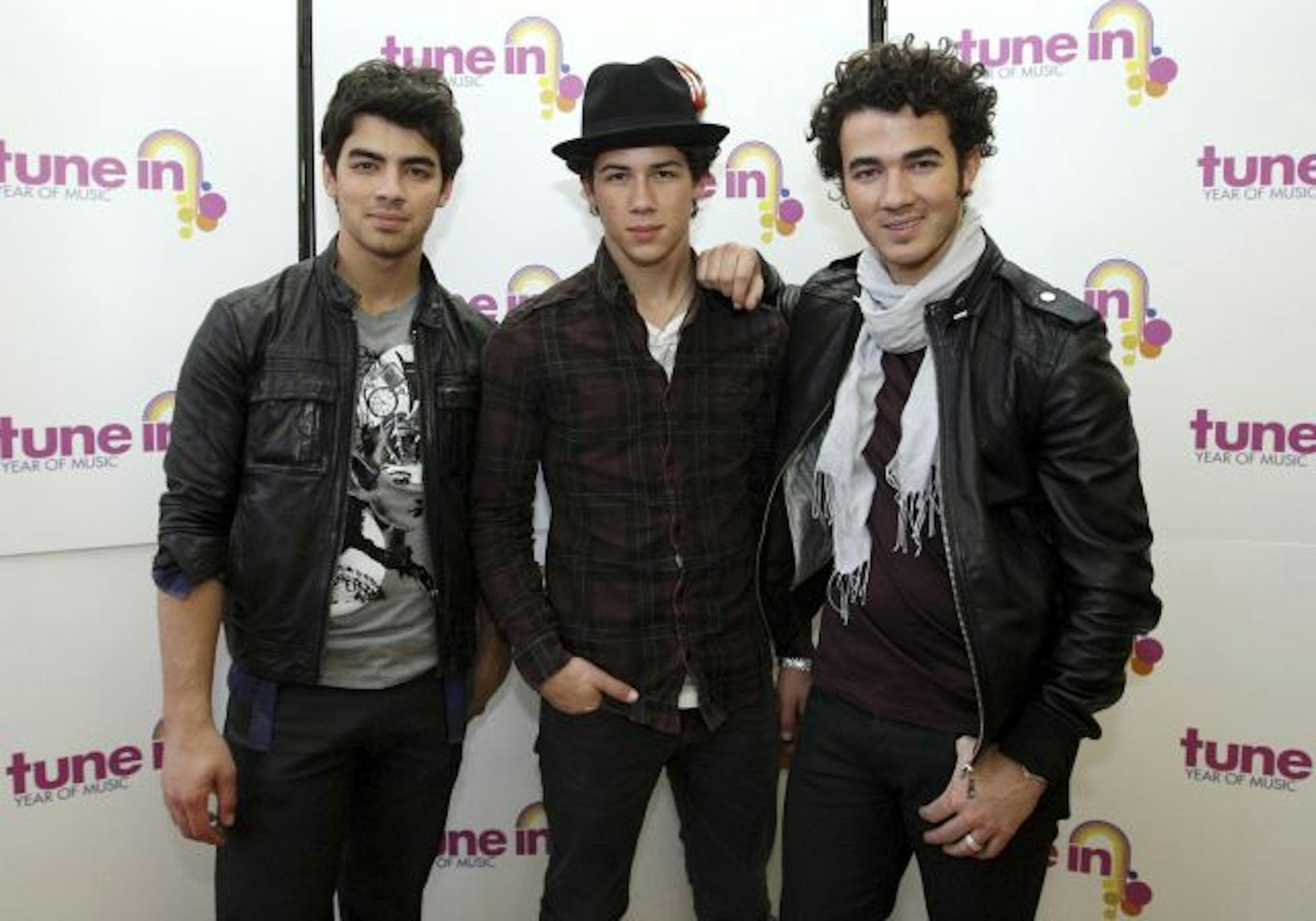 The Jonas Brothers, from left, Joe, Nick and Kevin Jonas pose for the media, ahead of the performance at Ryton High School, Ryton, England. Wednesday, Nov. 18, 2009 .The brothers gave a musical master class to a group of young people as part of the Department for Children, Schools and Families� campaign, Tune In � Year of Music.(AP Photo/Scott Heppell).