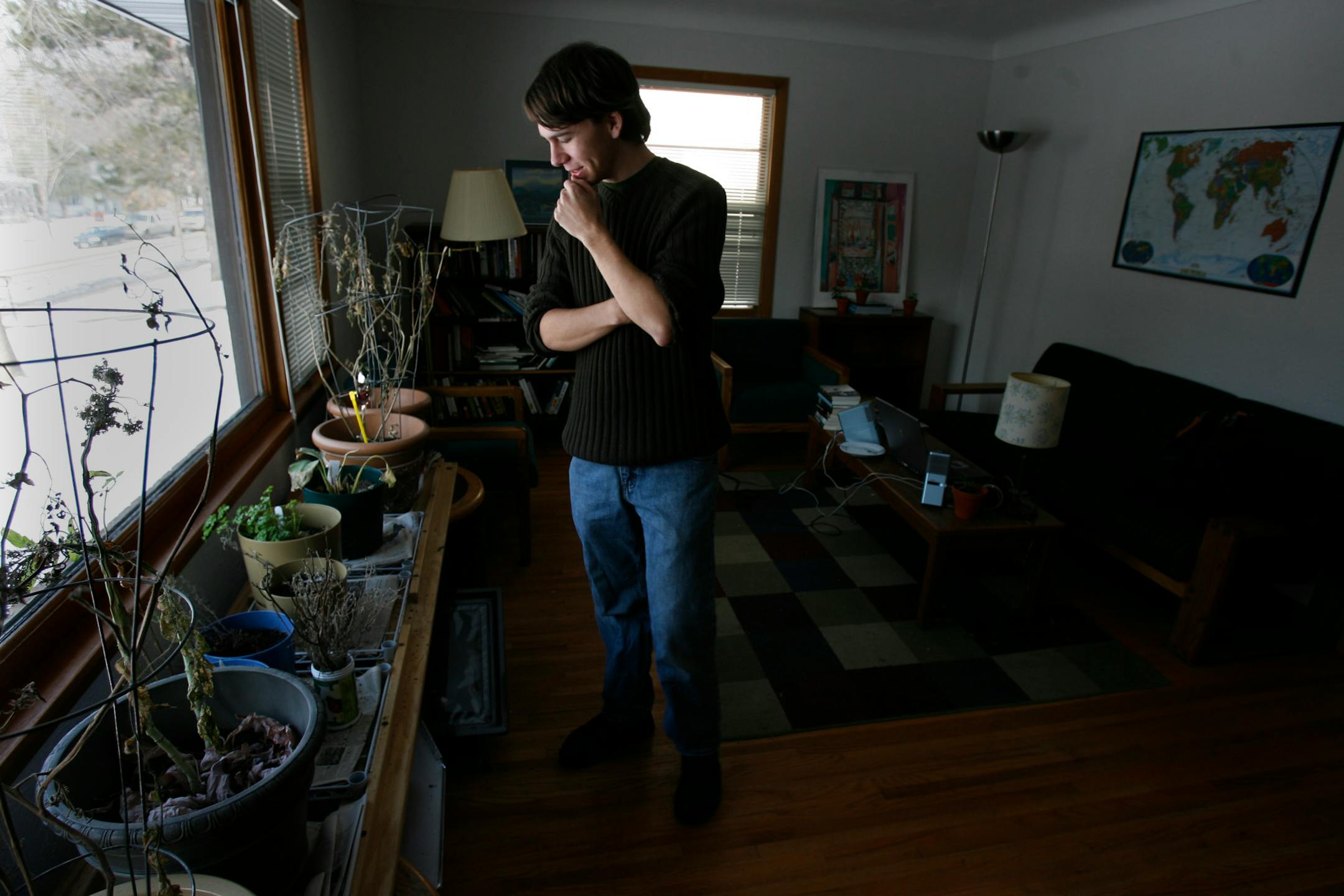 Austin Werth, a student at Macalaster College, stood in the living room of ECO student house.