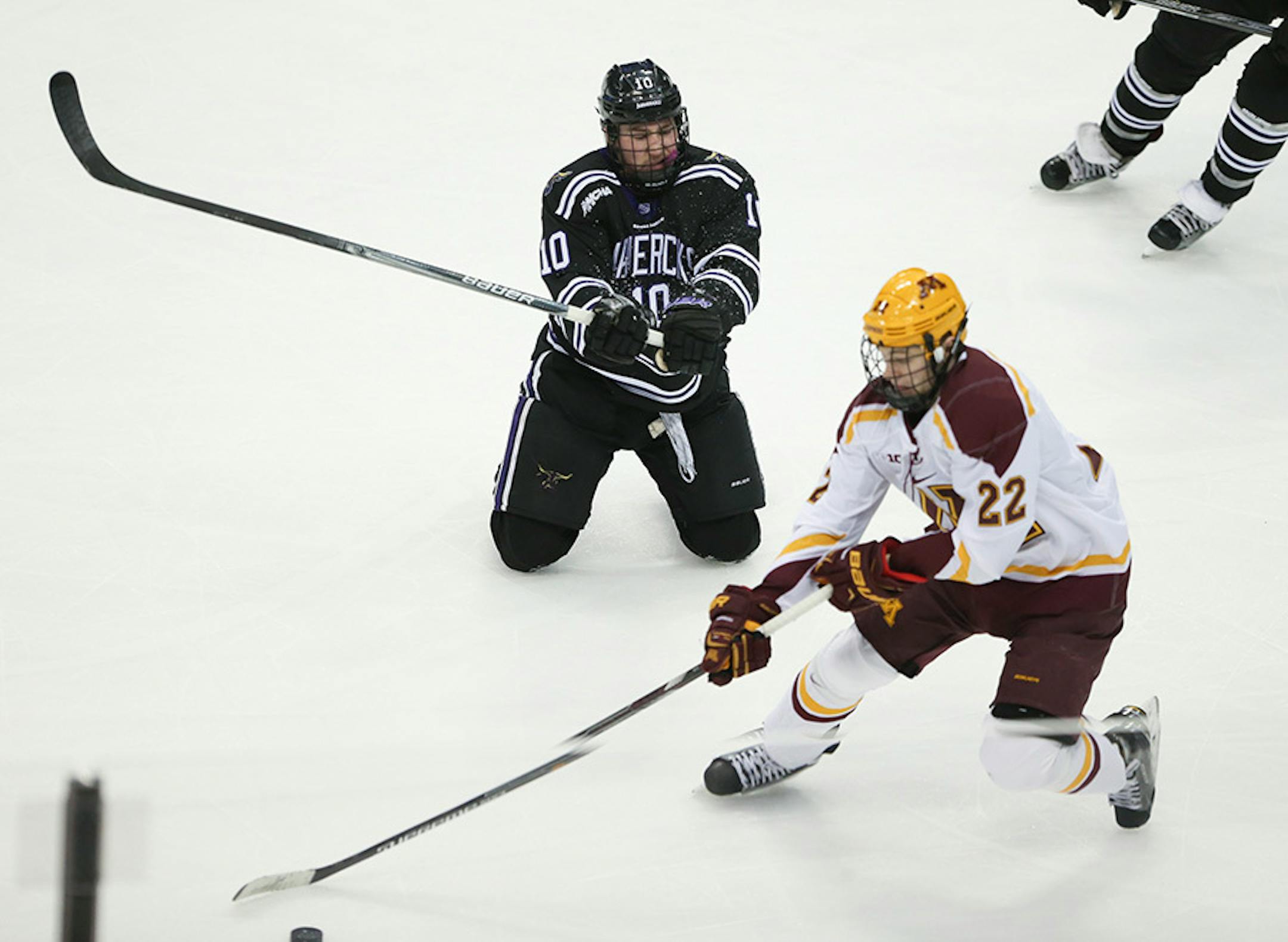 Mavericks forward Zeb Knutson (10) tried to defend after being tripped by Gophers forward Tyler Sheehy (22) in the first period Sunday afternoon. Sheehy was penalized on the play.