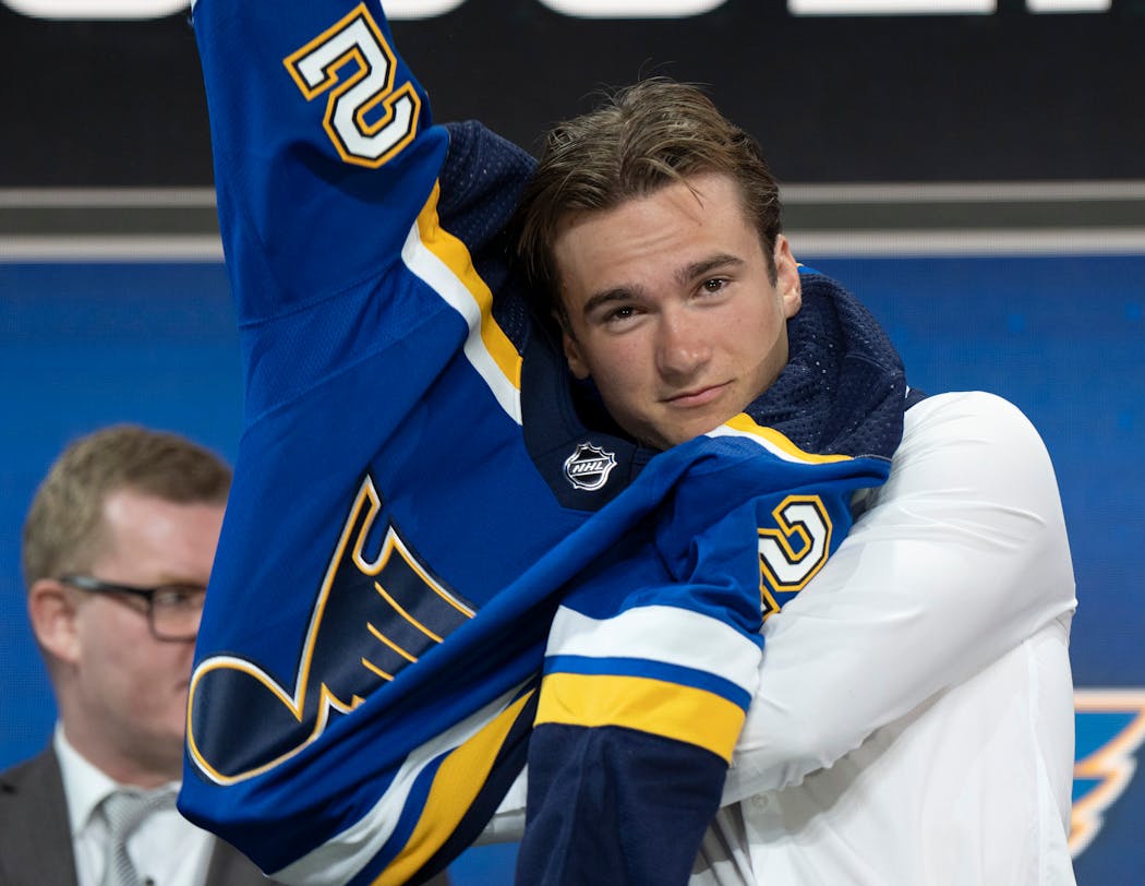 Jimmy Snuggerud pulled on a Blues jersey after St. Louis took the Chaska native 23rd overall on Thursday night in the NHL draft.
