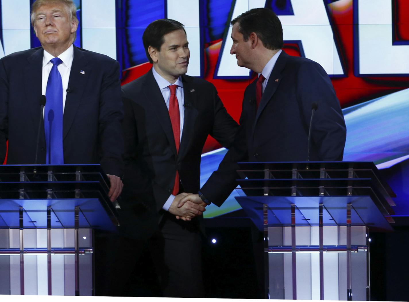 Donald Trump looks away as Sen. Marco Rubio and Sen. Ted Cruz converse during a break in the Republican presidential primary debate in Houston, Feb. 25, 2016. The debate hosted by CNN is the candidates' last before 11 states vote on Super Tuesday. (Eric Thayer/The New York Times) ORG XMIT: MIN2016022613405439