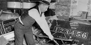 Hennepin County Deputy Sherriff C. V. Swanberg destroyed paraphernalia from a gambling club in 1939.