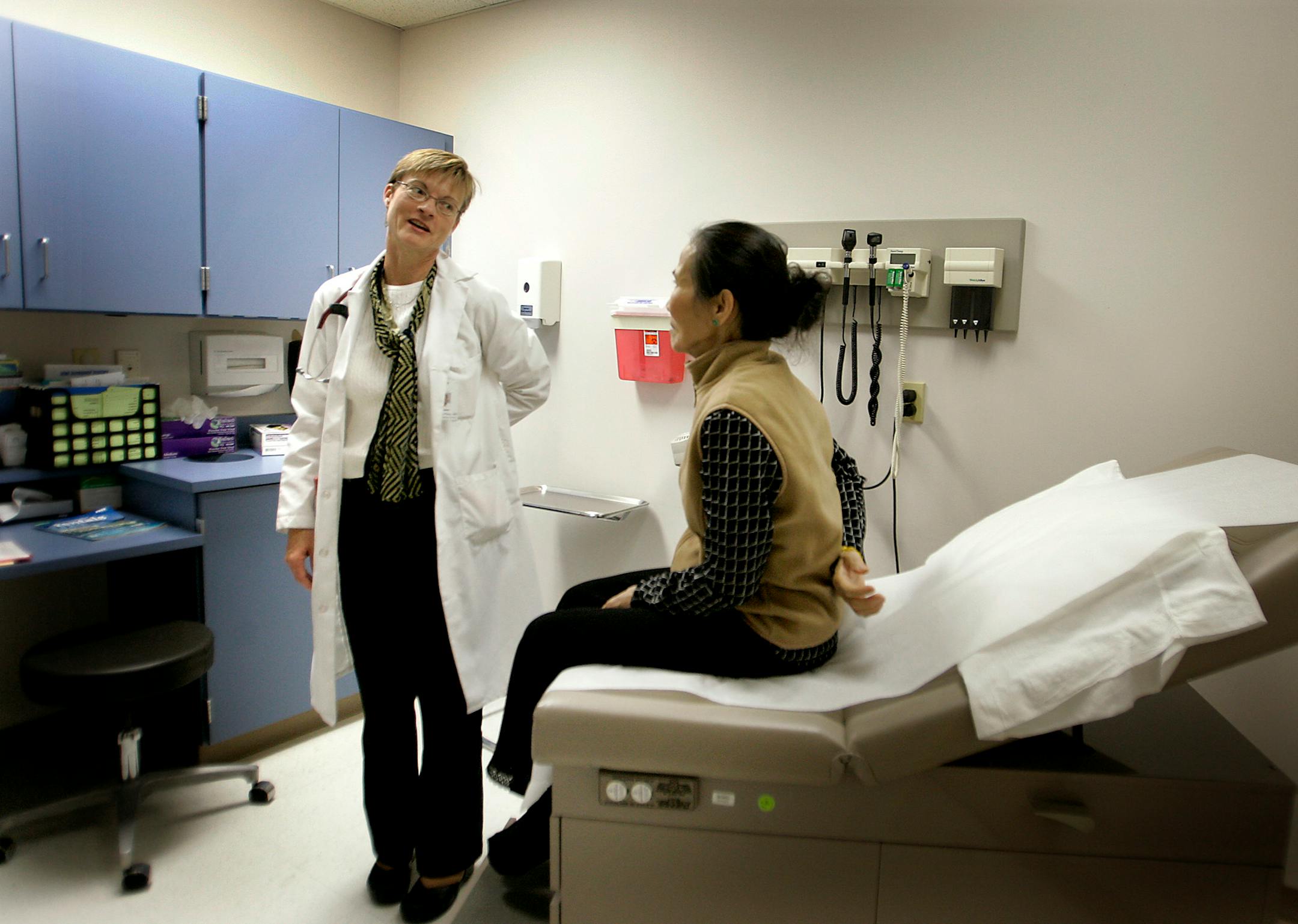 October 31, 2008 - St. Paul, MN - Vinh Ly attended a preventive care appointment under Dr. Kathleen Culhane-Pera at the East Side Family Clinic. Ly, who was there with her son-in-law Trong Vu, was there to get her flu shots and a basic check-up. Starting January, west metro hospitals are going to start paying for some preventive care for the uninsured to stop them from showing up for emergency care later. The East Side Family Clinic has had the program - run by an organization called Portico - f