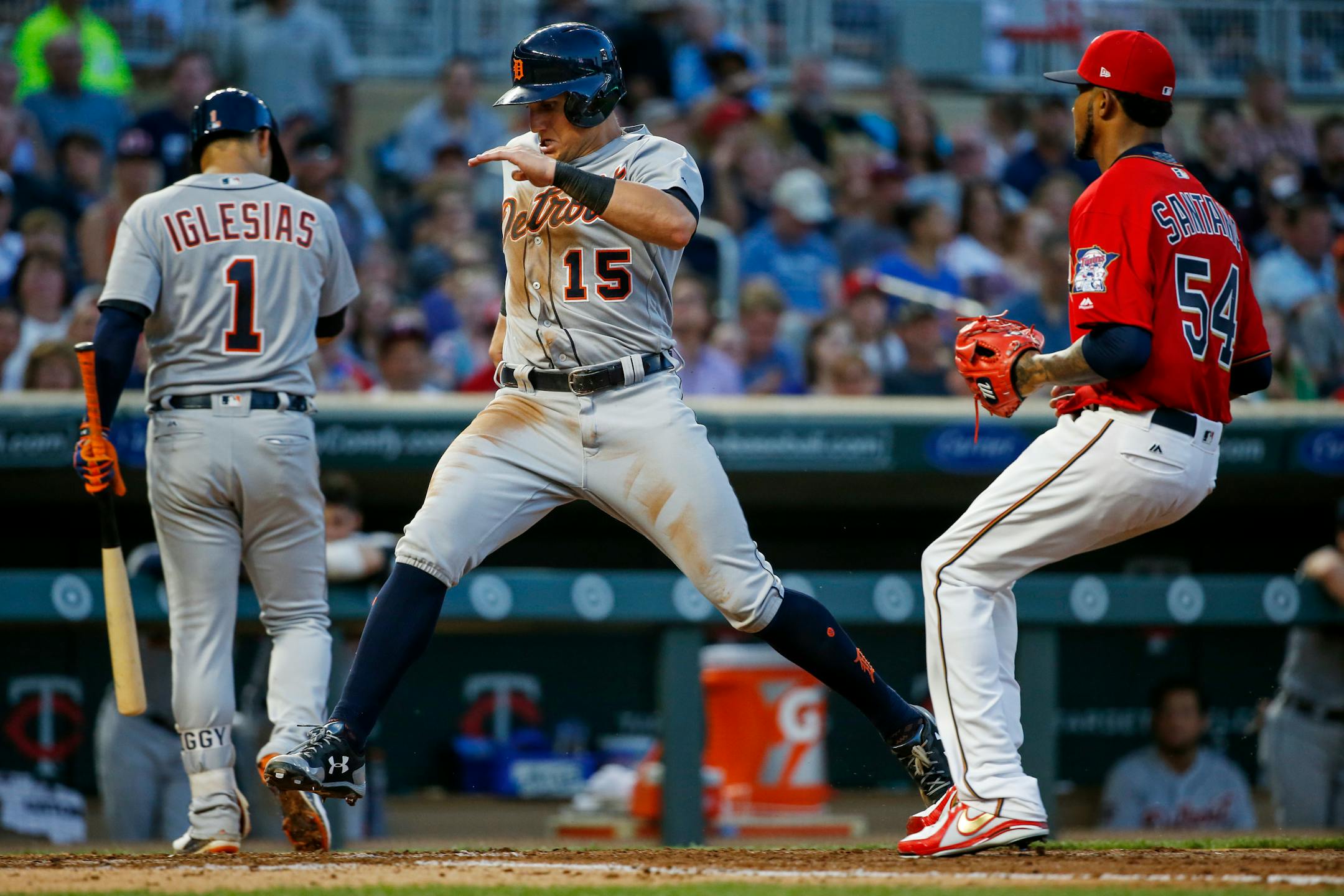 Detroit Tigers' Mikie Mahtook, center, scores ahead of Minnesota Twins starting pitcher Ervin Santana, right, on a wild pitch in the fourth inning of a baseball game Friday, July 21, 2017, in Minneapolis. (AP Photo/Bruce Kluckhohn)