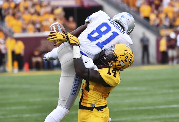 Minnesota defensive back Zo Craighton breaks up a pass to Middle Tennessee wide receiver CJ Windham (in the fist half of a NCAA college football game 